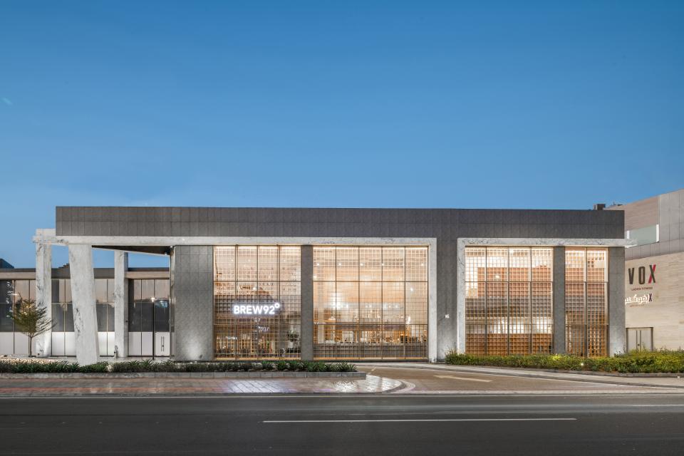 Modern coffee shop exterior featuring 'Japandi' design elements, showcasing Brew92's flagship store architecture and inviting storefront.