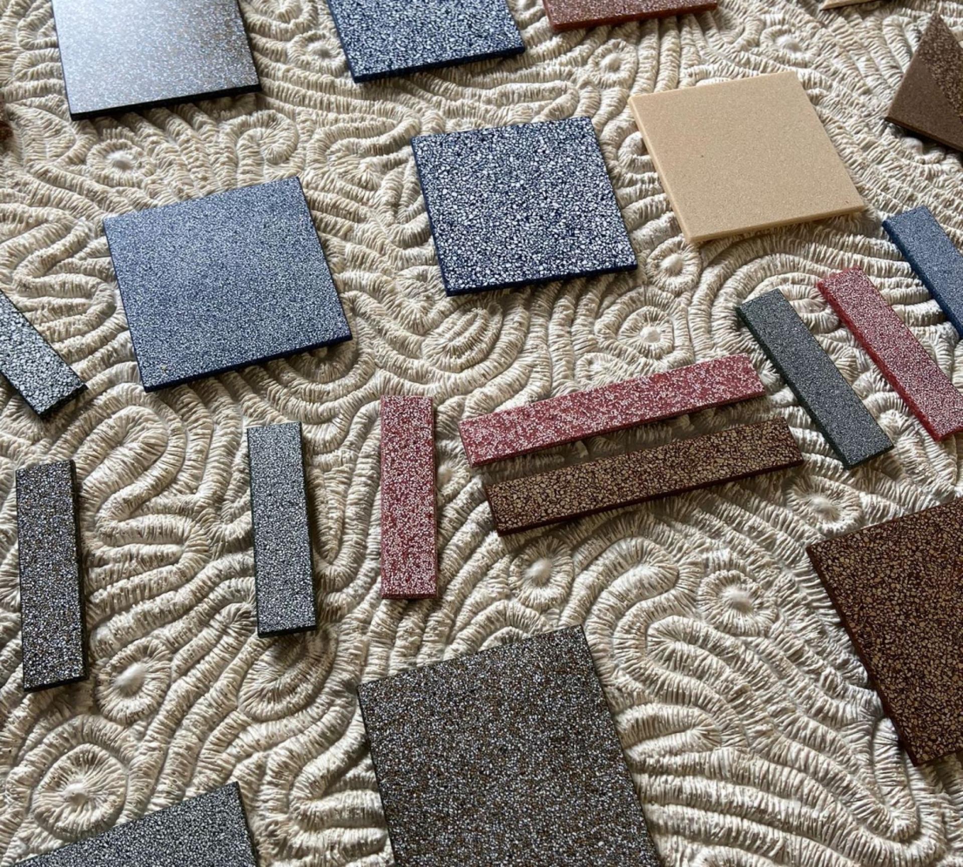 Diverse sustainable biomaterial samples arranged on a textured surface, showcasing innovative design at LDF22.