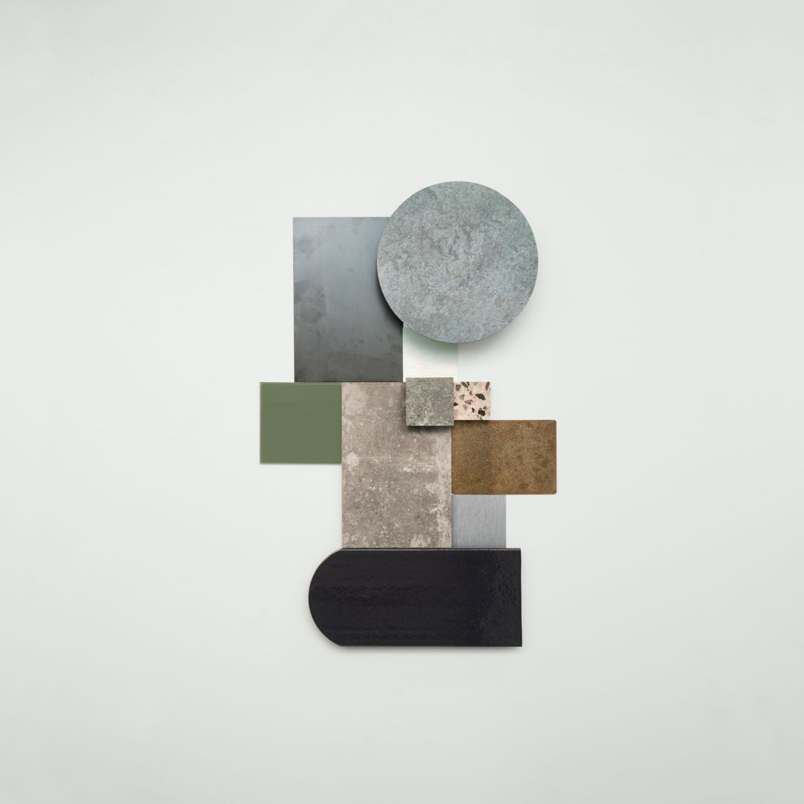 Natural-inspired color palette featuring geometric shapes in shades of green, gray, and brown from Forbo's Marmoleum Marbled collection.