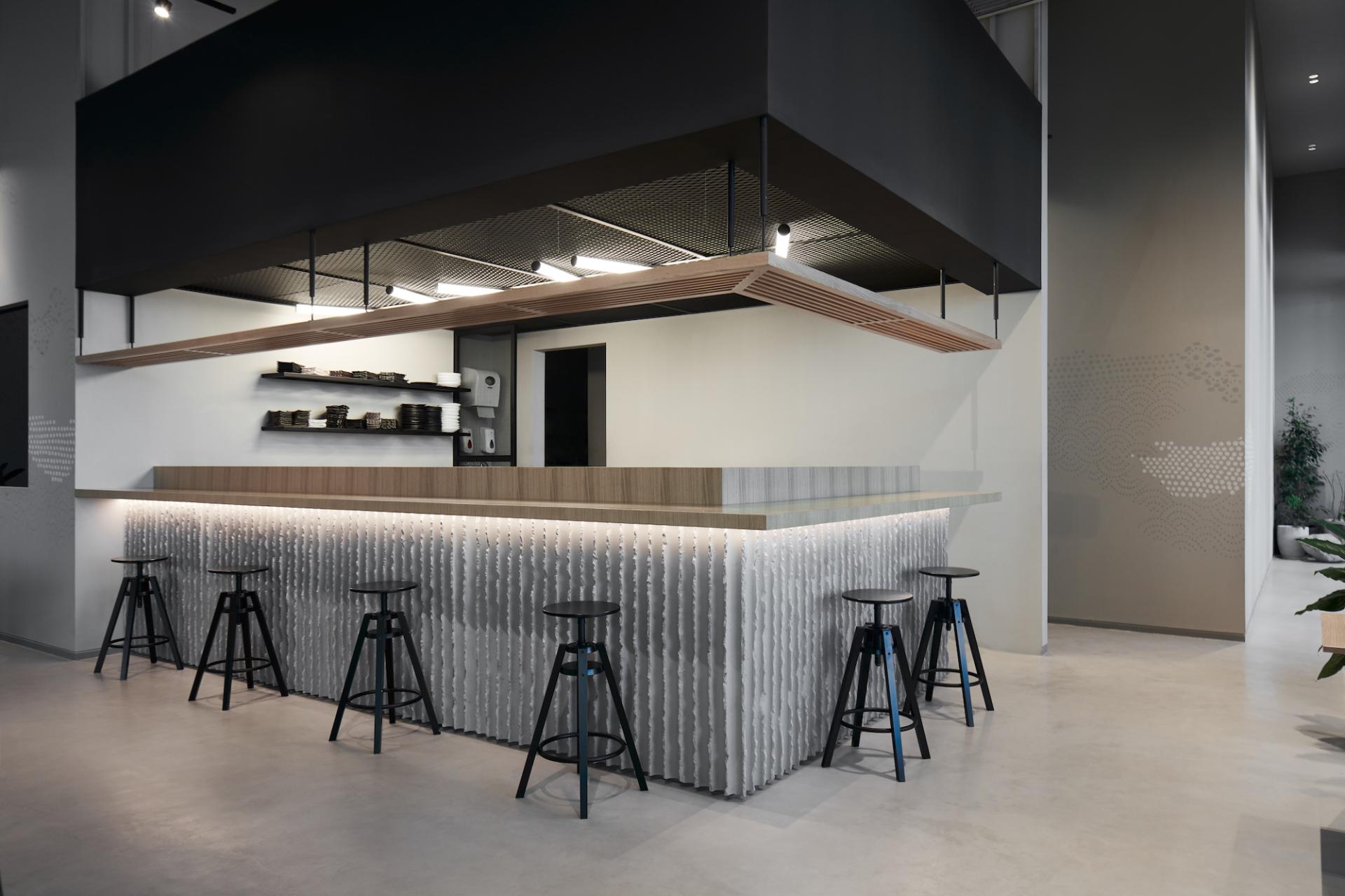 Stylish interior of Origami restaurant in Dubai featuring a modern bar, sustainable design, and functional Ikea furniture.