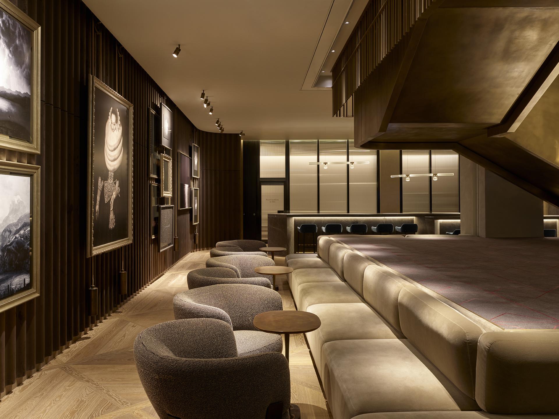 Luxurious lobby interior of Leicester Square hotel, featuring elegant seating, artistic wall decor, and ambient lighting.