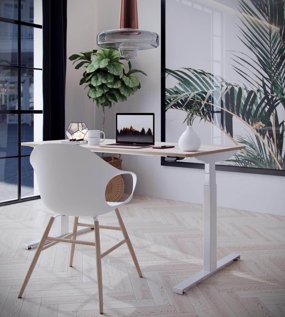 Modern Hi-Lo desk in a stylish workspace with a laptop, plant, and decorative elements for improved workplace wellbeing.