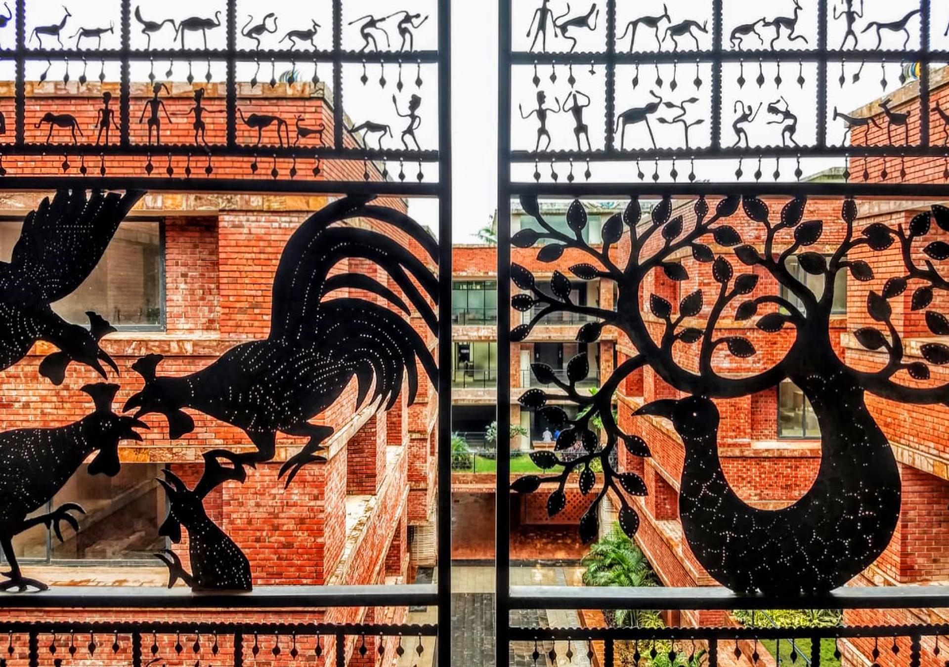 Intricately designed metalwork featuring animals and foliage, showcasing the unique architecture of Krushi Bhawan by Studio Lotus.