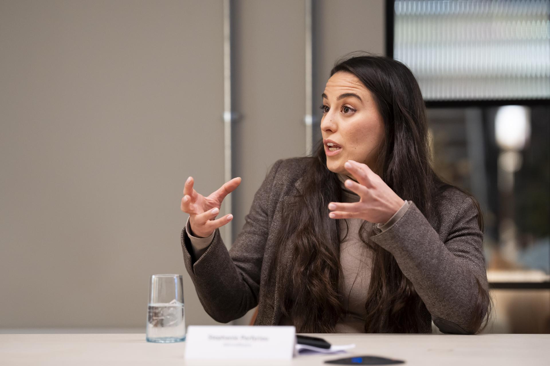 A woman engaging in discussion about data's impact on the workplace, emphasizing technology's role in modern environments.
