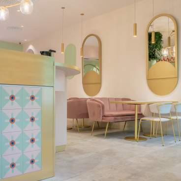 Stylish interior of Linfa Milano featuring pastel seating, elegant decor, and unique furnishings by S•CAB.