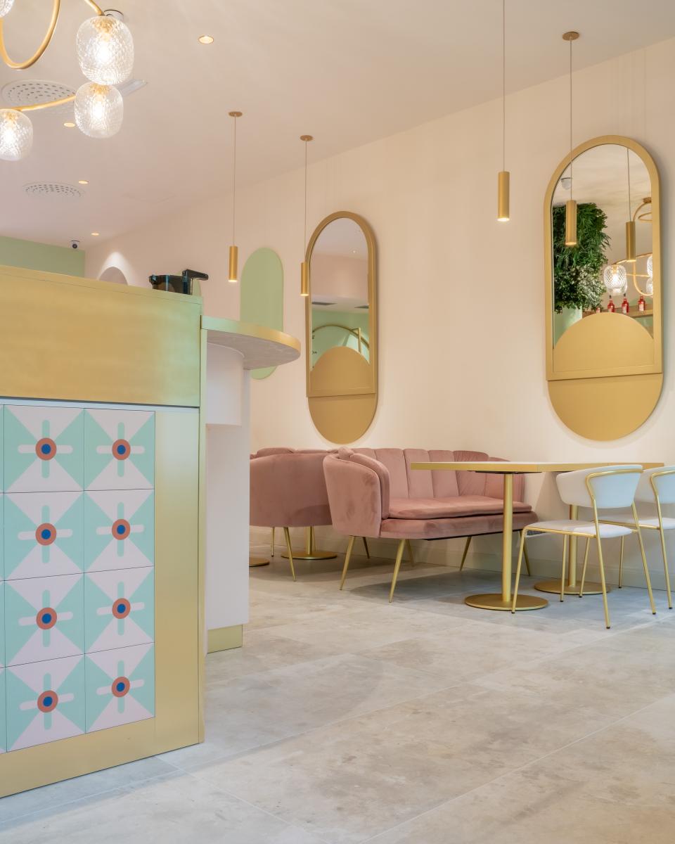 Stylish interior of Linfa Milano featuring pastel seating, elegant decor, and unique furnishings by S•CAB.