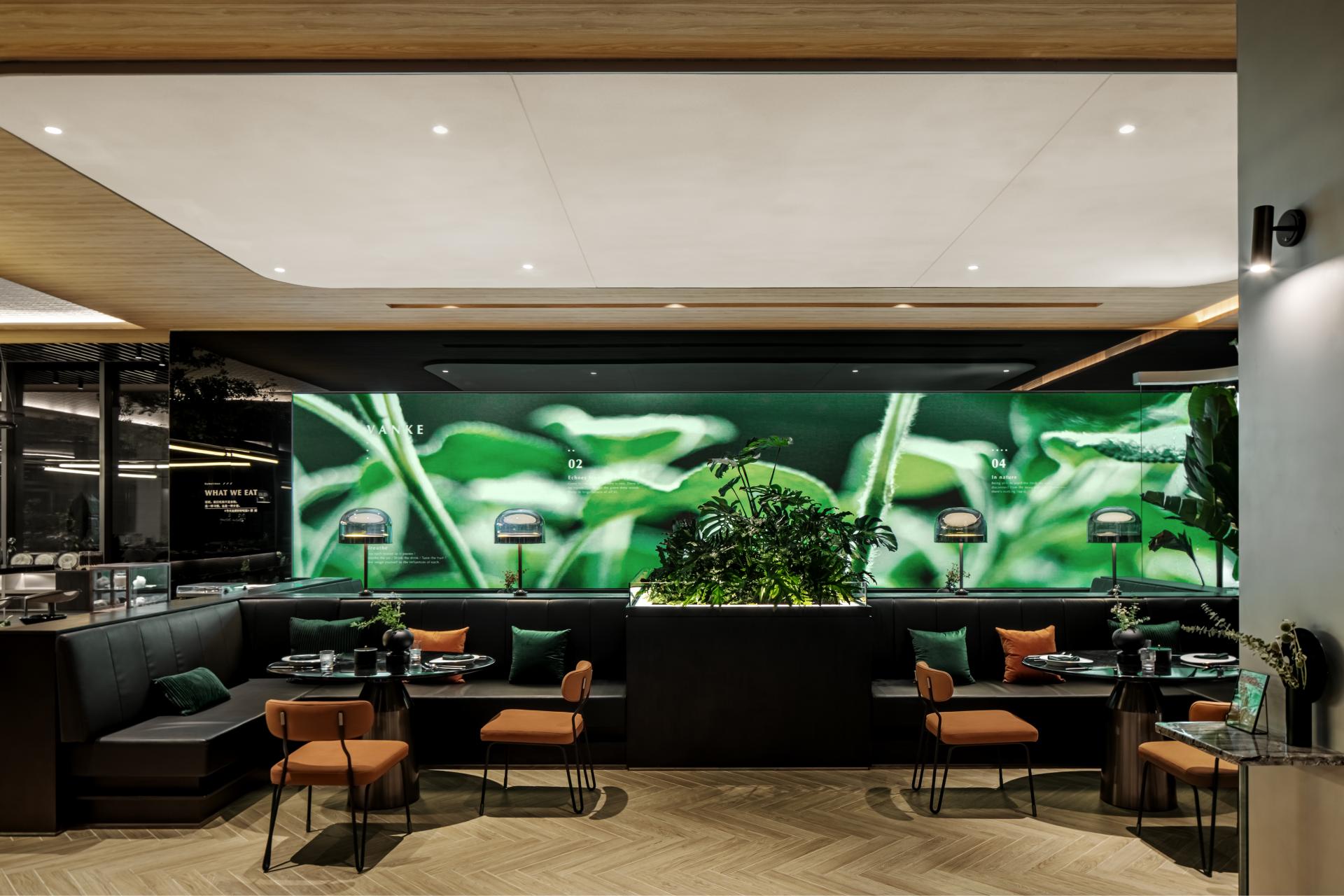 Nature-themed restaurant interior featuring lush greenery, artistic design, and cozy seating for a vibrant dining experience.
