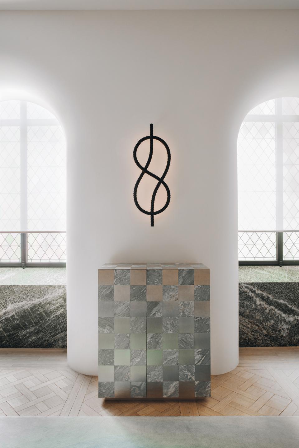 Modern furniture piece with a geometric lighting design by Mathieu Lehanneur, highlighting elegance and innovative craftsmanship.