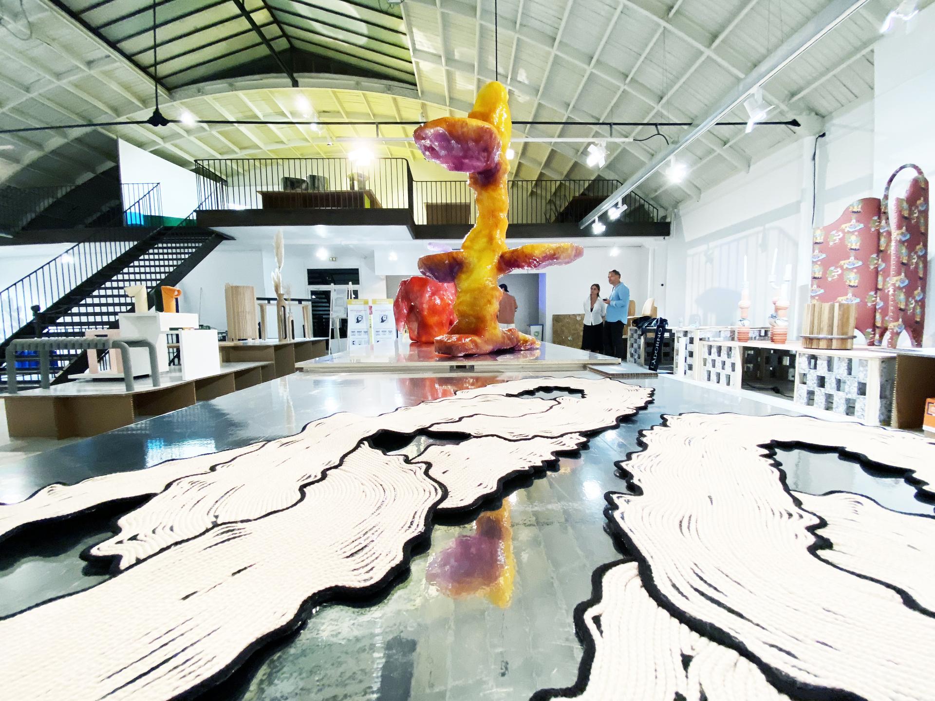 Colorful abstract sculpture centerpiece in a contemporary gallery setting during Paris Design Week, showcasing Adorno's "Matérialité" collection.