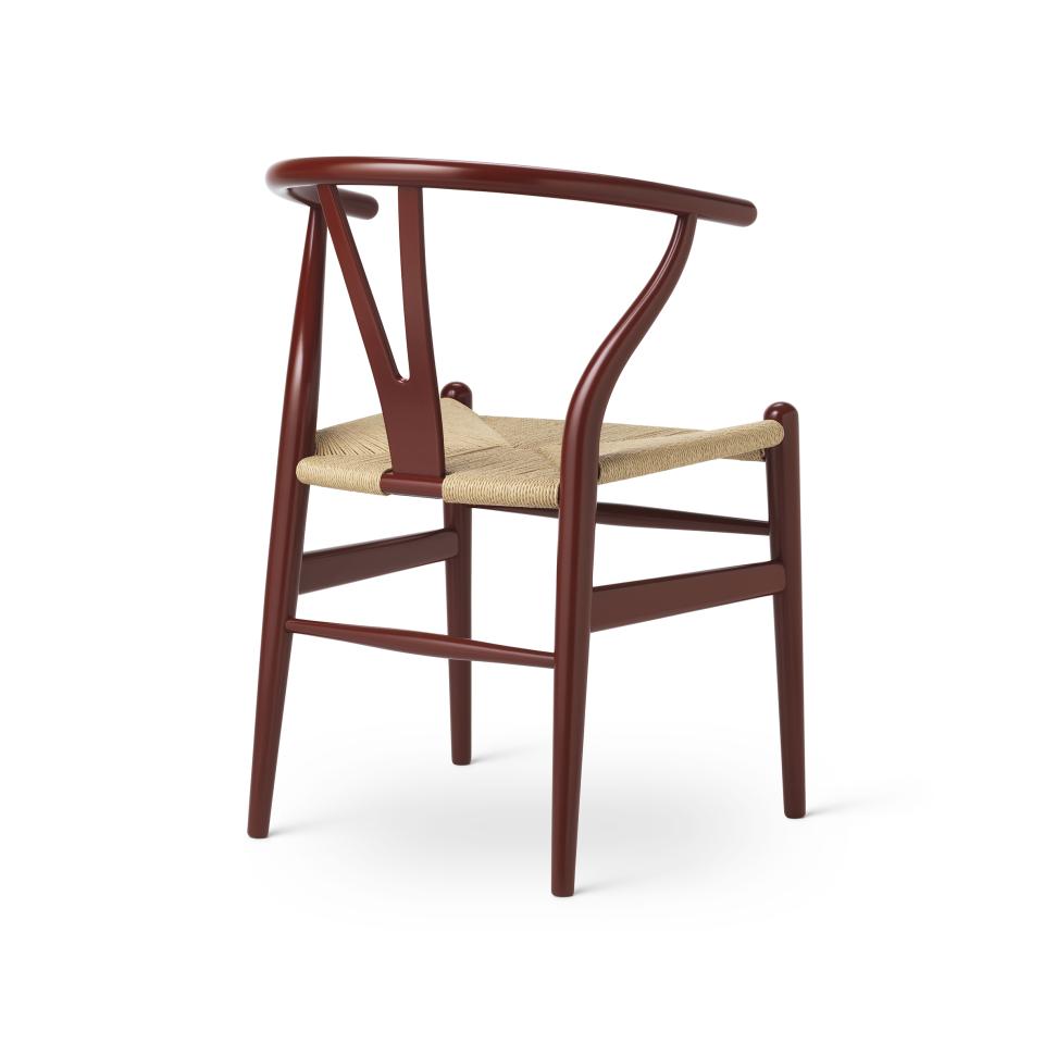 Wishbone chair by Carl Hansen & Son in a rich mahogany finish with a woven seat, showcasing nature-inspired design elements.
