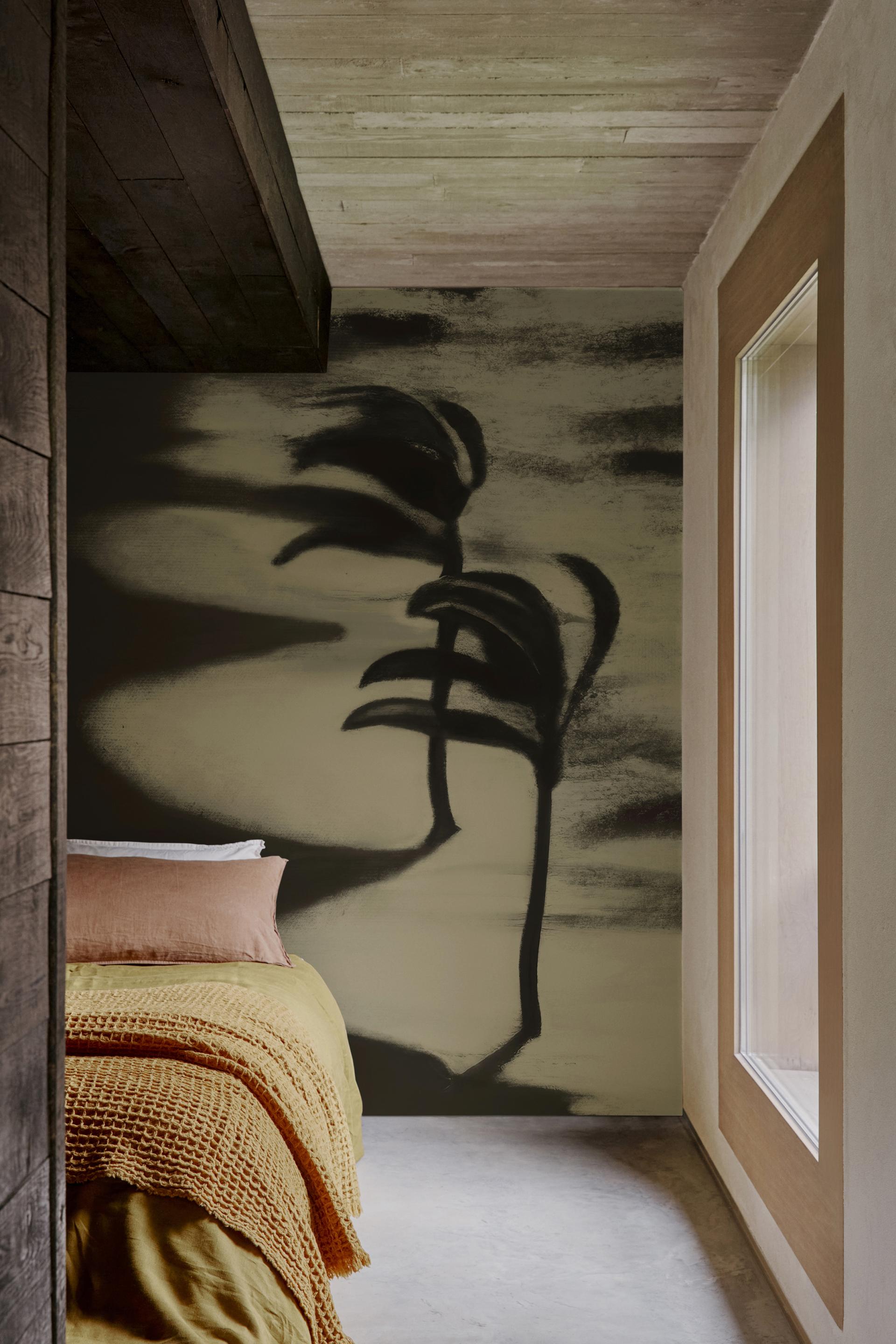 Contemporary bedroom featuring bold b&w wallpaper design, rich textures, and warm bedding from Wall&decò's 2023 collection.