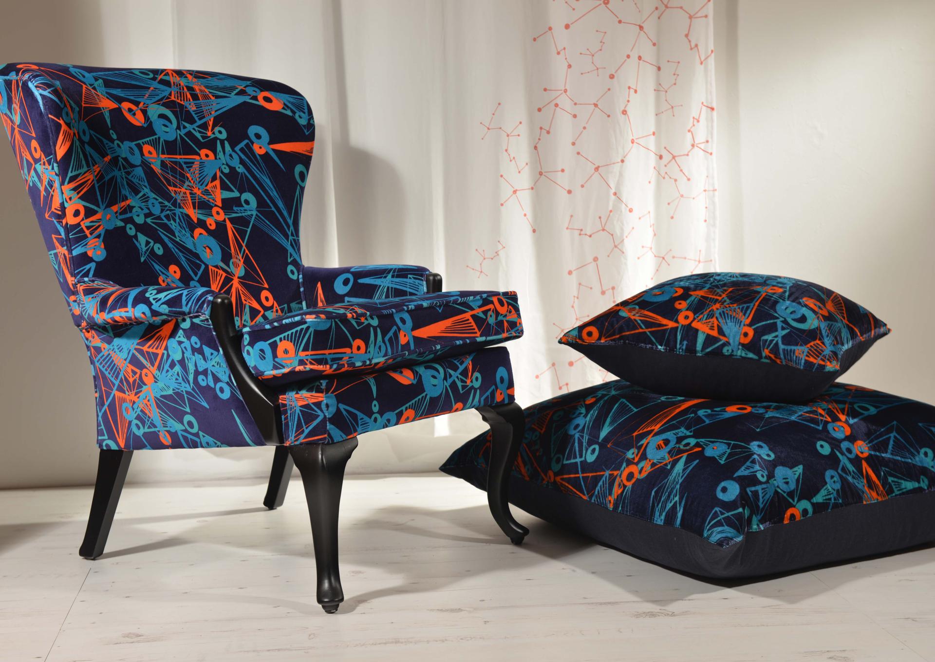 Vibrant armchair and cushions featuring bold, geometric patterns, showcasing Moody Monday's unique textile designs in an Edinburgh setting.