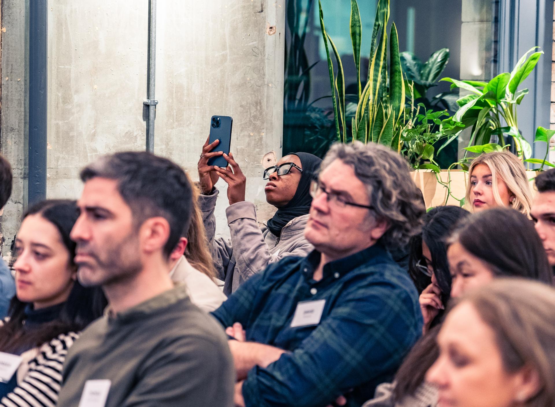 Audience members engaged in a discussion about achieving Net Zero, highlighting the urgency of materiality in sustainability efforts.