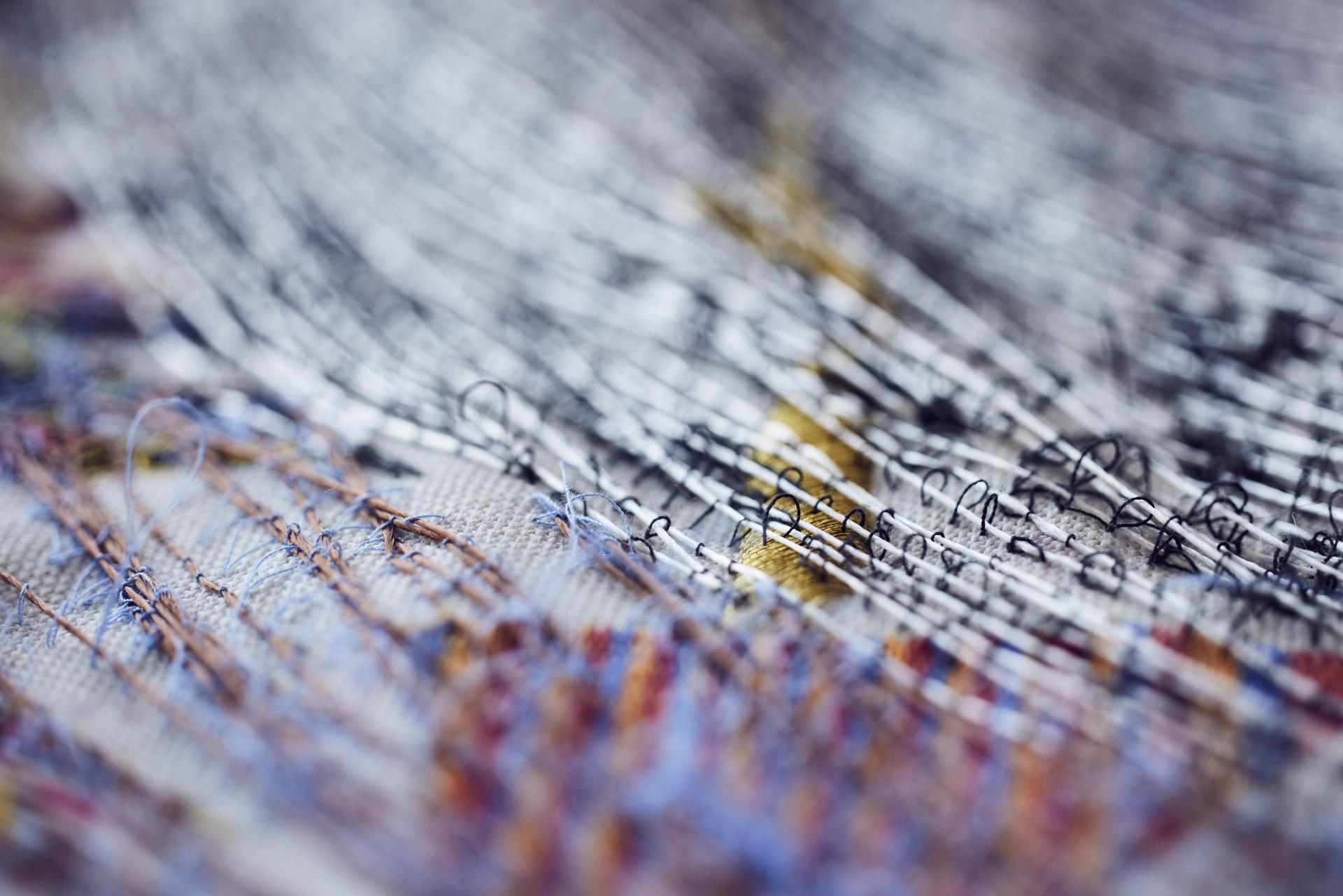 Intricate textile art showcasing detailed stitching and colorful threads, reflecting innovation in Manchester's craft scene.