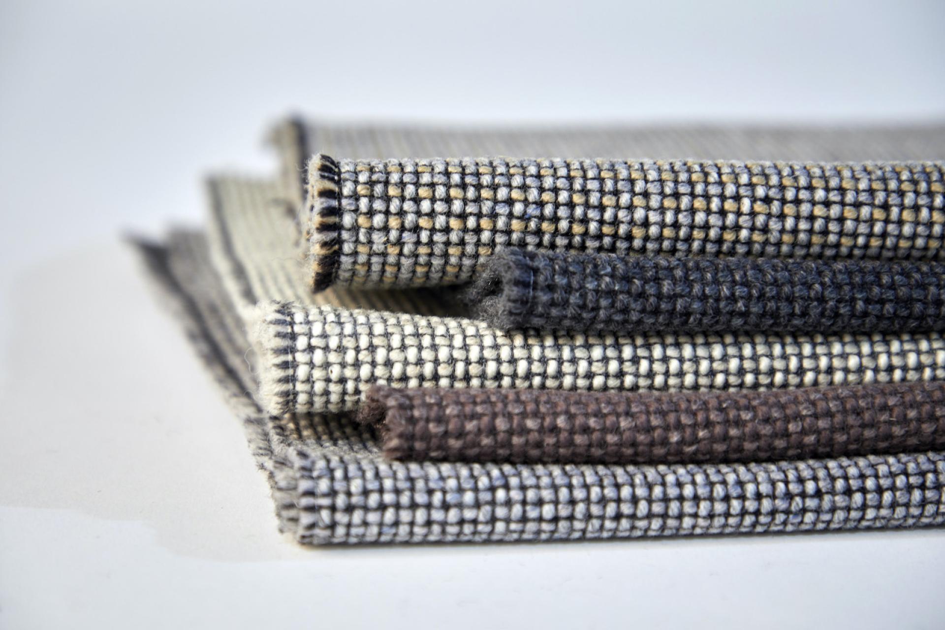 Textiles made from sustainable materials, showcasing Camira's Craggan Flax in various deep textures and natural colors.