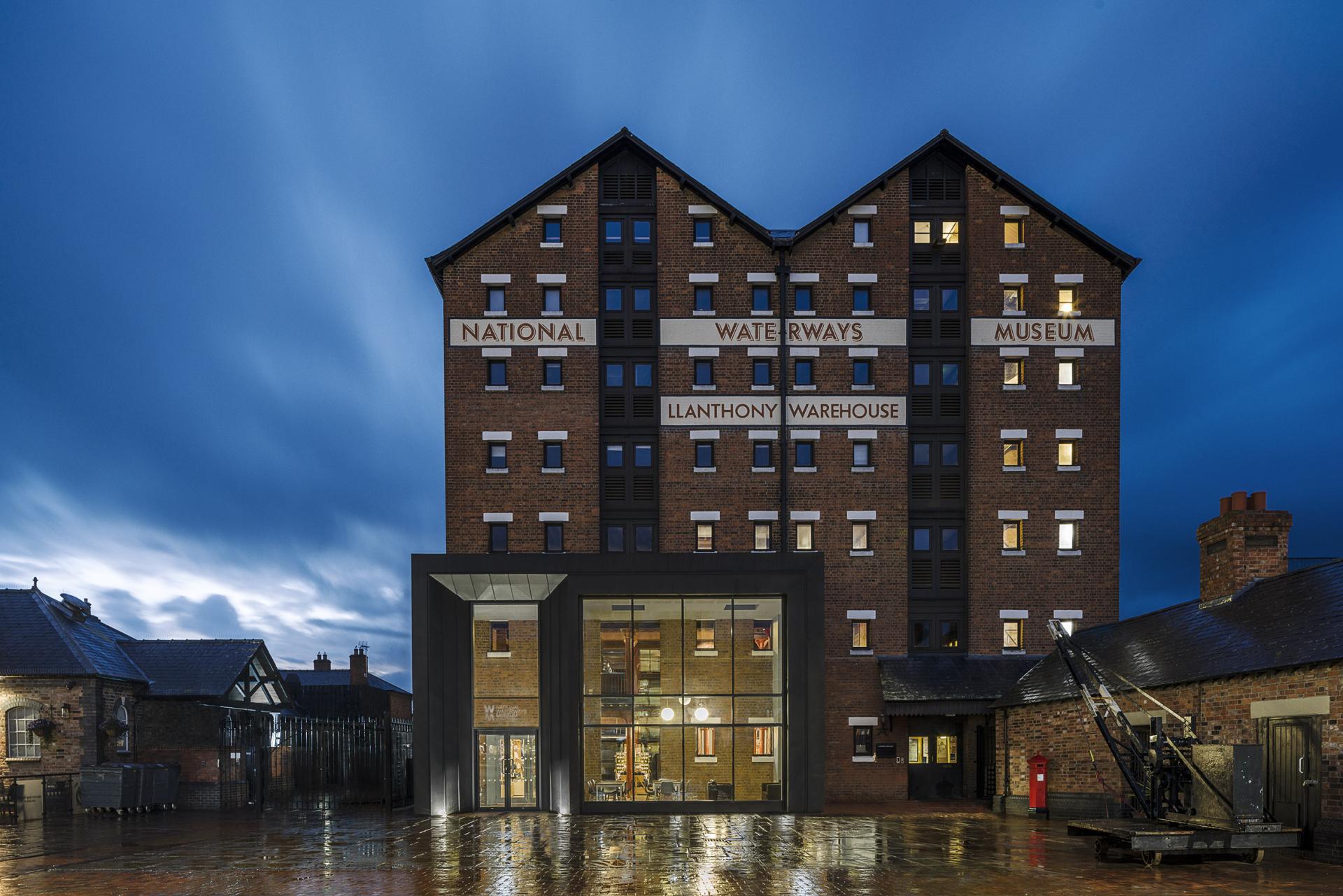 The National Waterways Museum at Llanthony Warehouse features a contemporary entrance under a dramatic evening sky.
