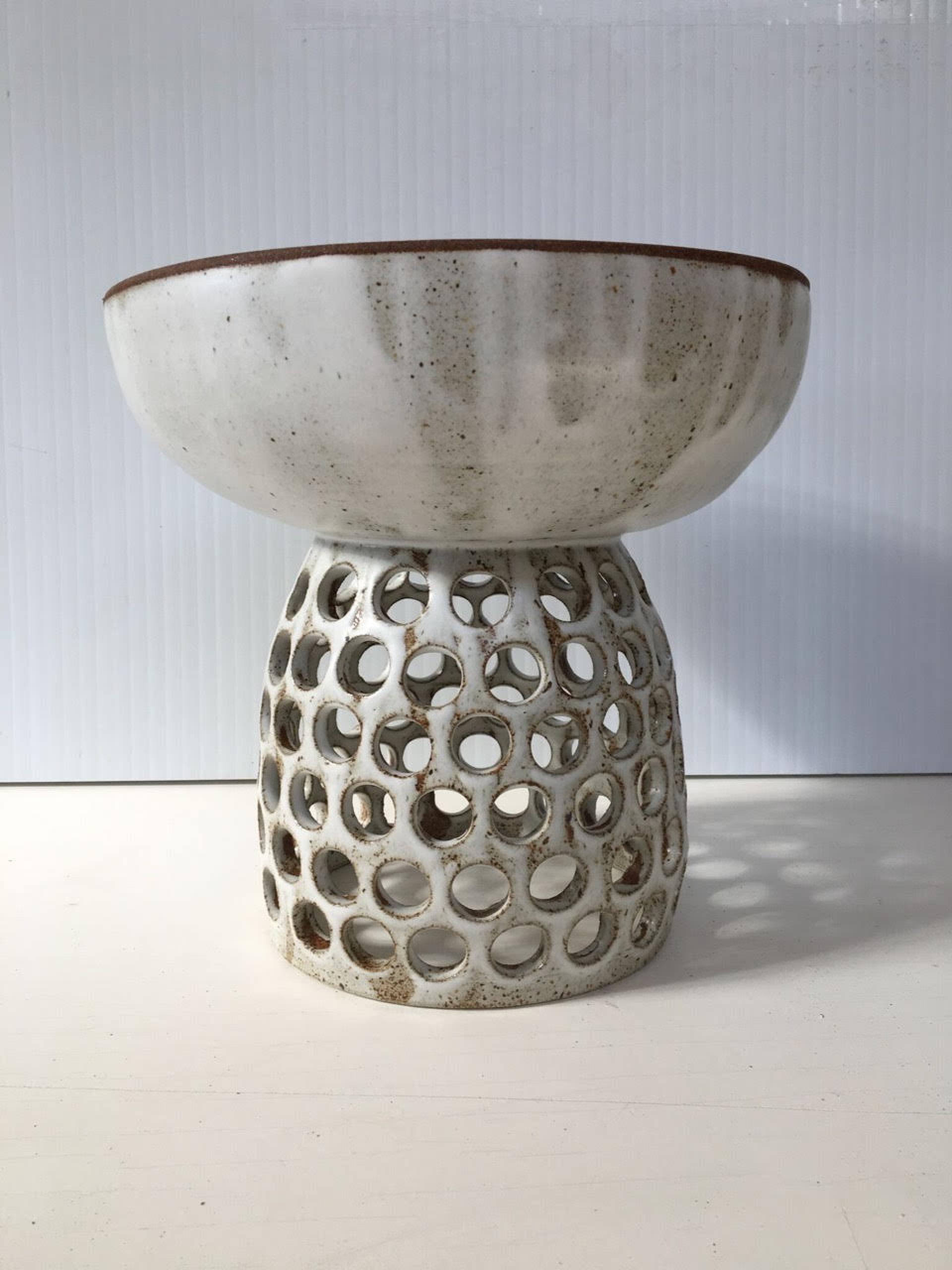 Vintage stoneware ceramic bowl on a perforated base, showcasing Heather Levine's unique design inspired by California aesthetics.