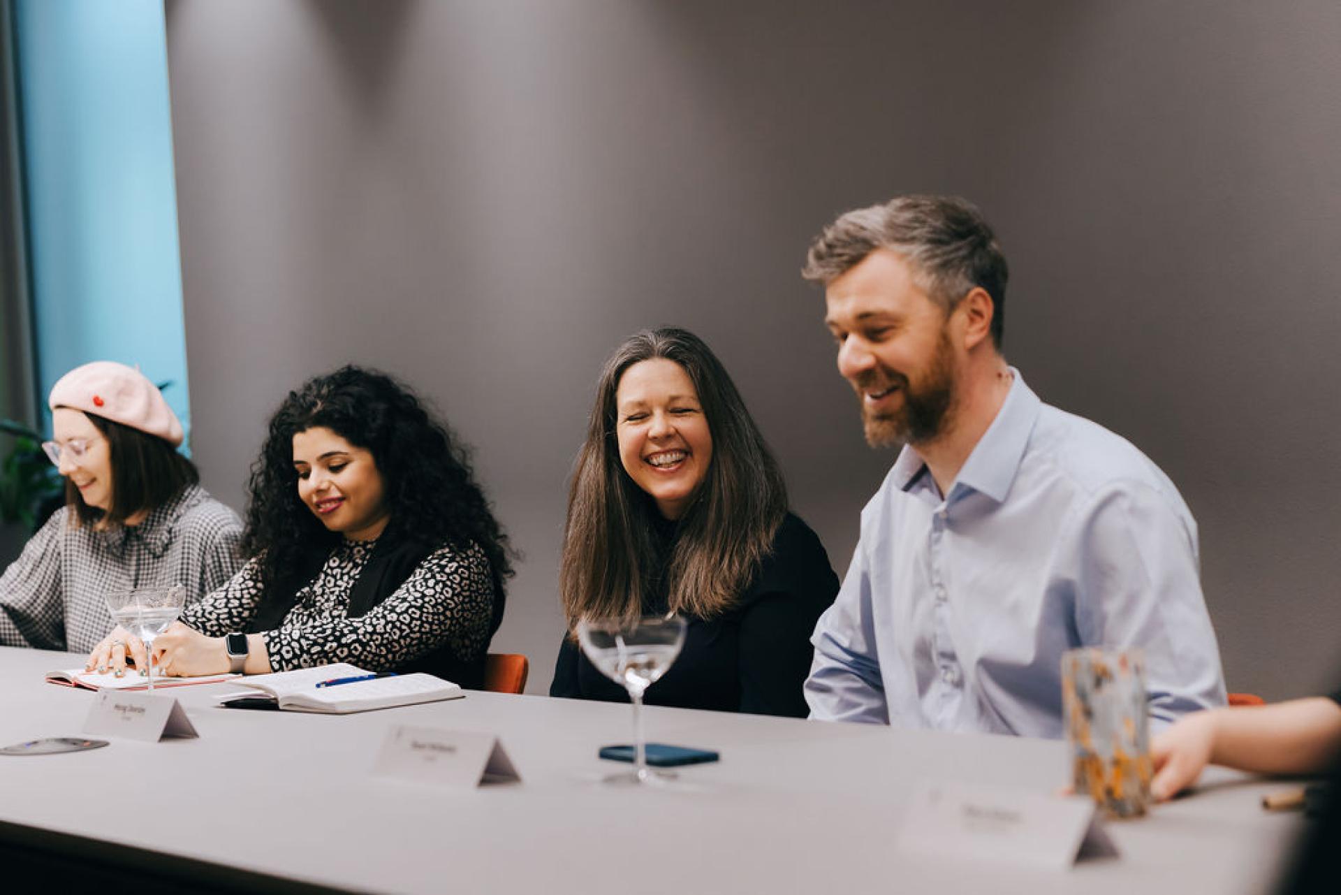 Diverse group of professionals discussing biomaterials at a roundtable event focused on sustainability and innovation.
