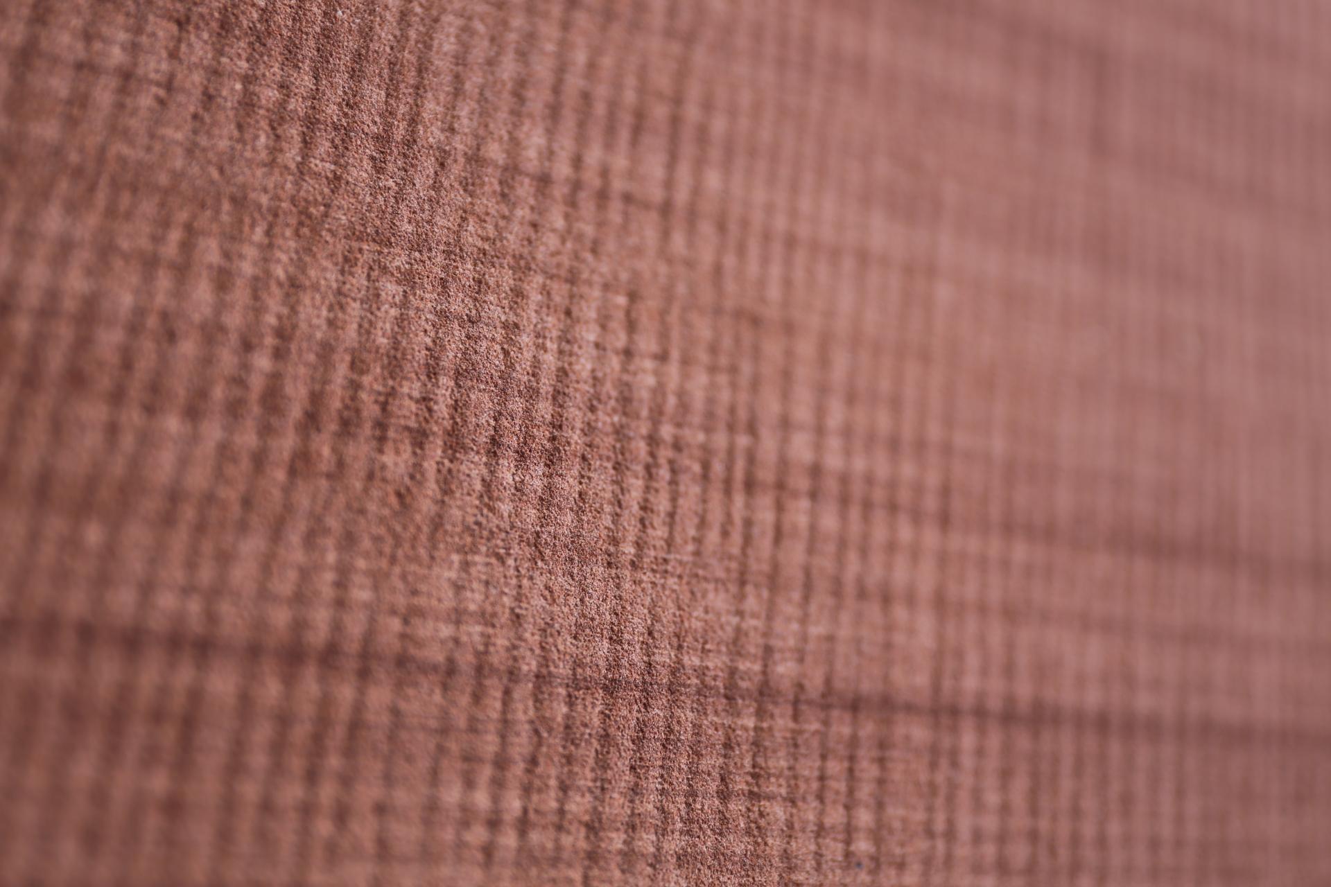 Textured fabric in warm tones, highlighting the quality and craftsmanship of David Irwin's collaboration with Bute Fabrics.