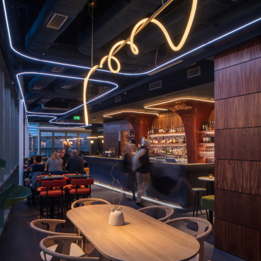 Stylish interior of M'Arks Sky Bar in London, featuring modern lighting, elegant furnishings, and a vibrant bar atmosphere.