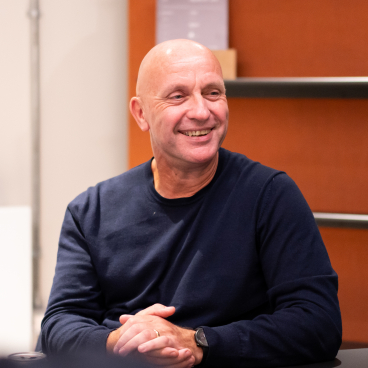 Nick Atkin, CEO of Yorkshire Housing, smiling during a meeting about the UK residential market.