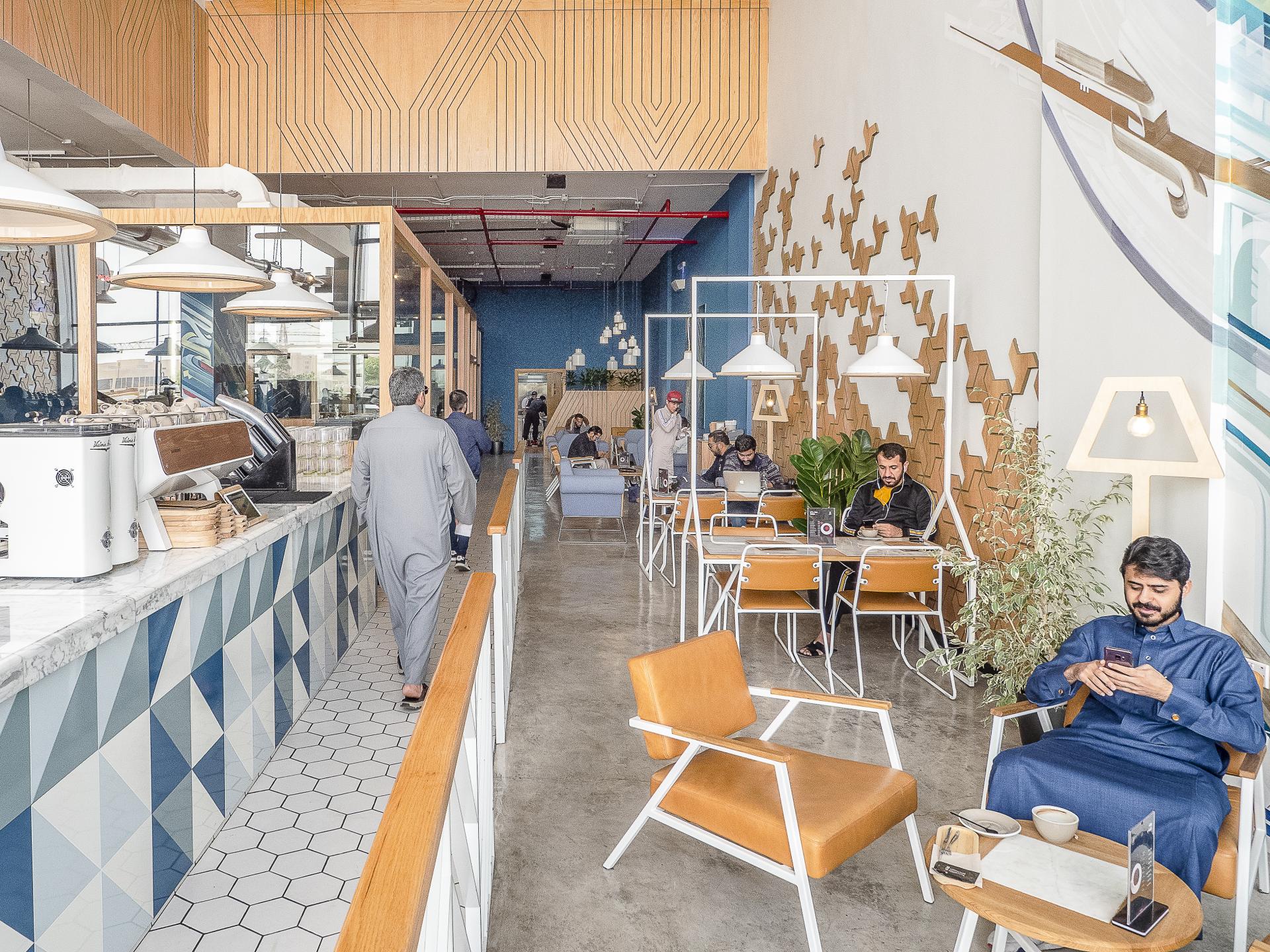 Stylish interior of Brew92 cafe featuring modern seating, a coffee bar, and patrons enjoying the unique design.