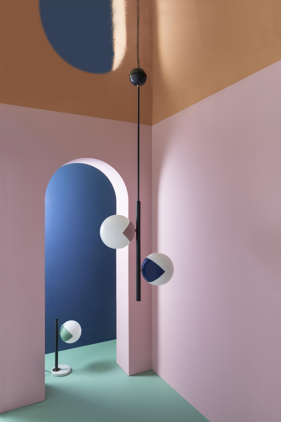 Colorful 'eyeball' lamps by Magic Circus Éditions are elegantly suspended in a pastel-toned room with geometric accents.