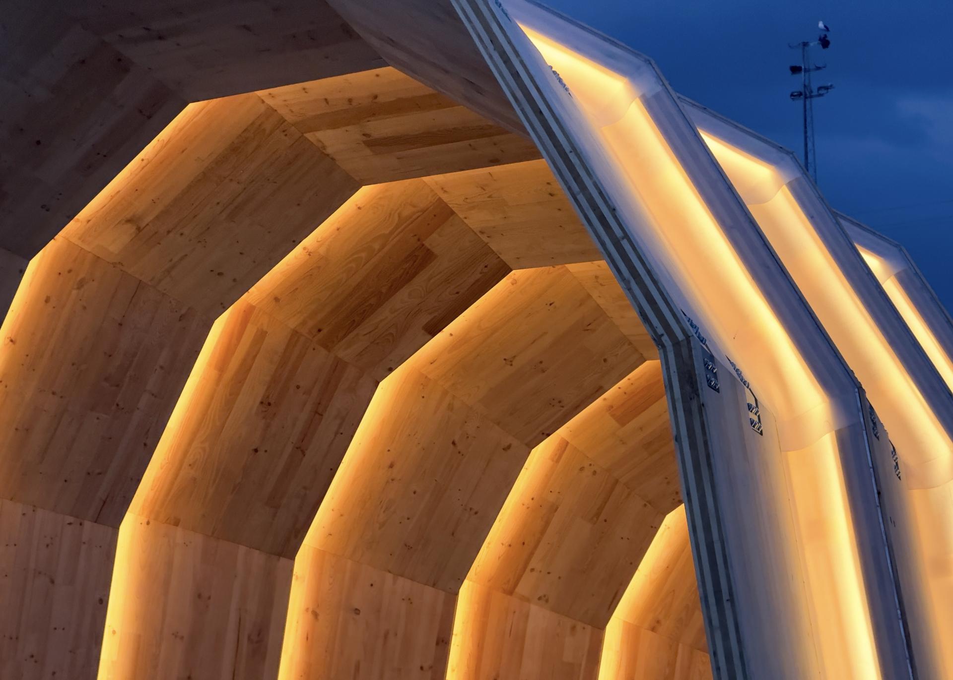 Eucalyptus CLT structure of The Armadillo showcasing illuminated wooden interiors in a modern architectural design.