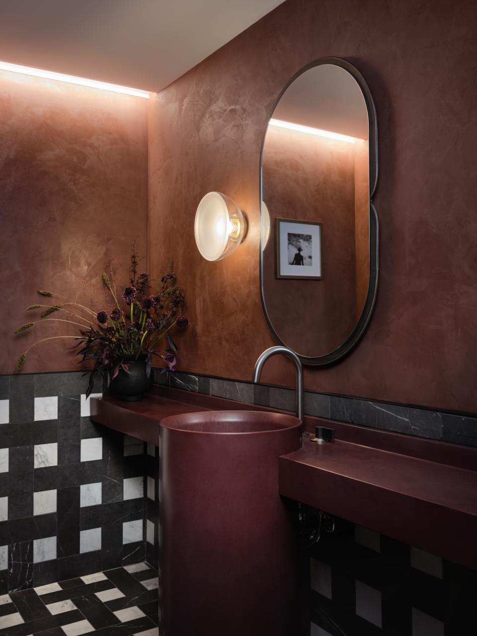 Chic restroom interior featuring a sculptural sink, modern lighting, and elegant decor at Park Lane New York.