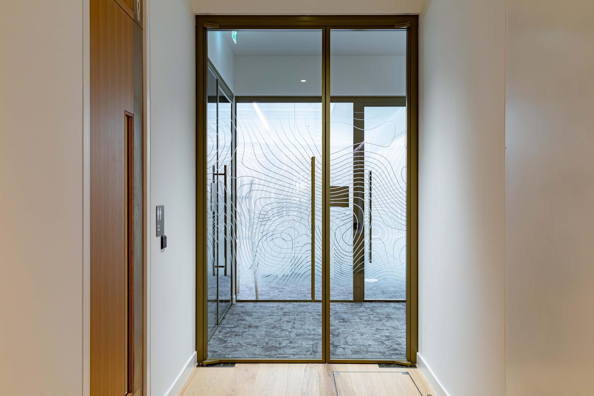 Radii supports tp bennett & Overbury with bespoke bronze framed glazed partitions at banking HQ in London.