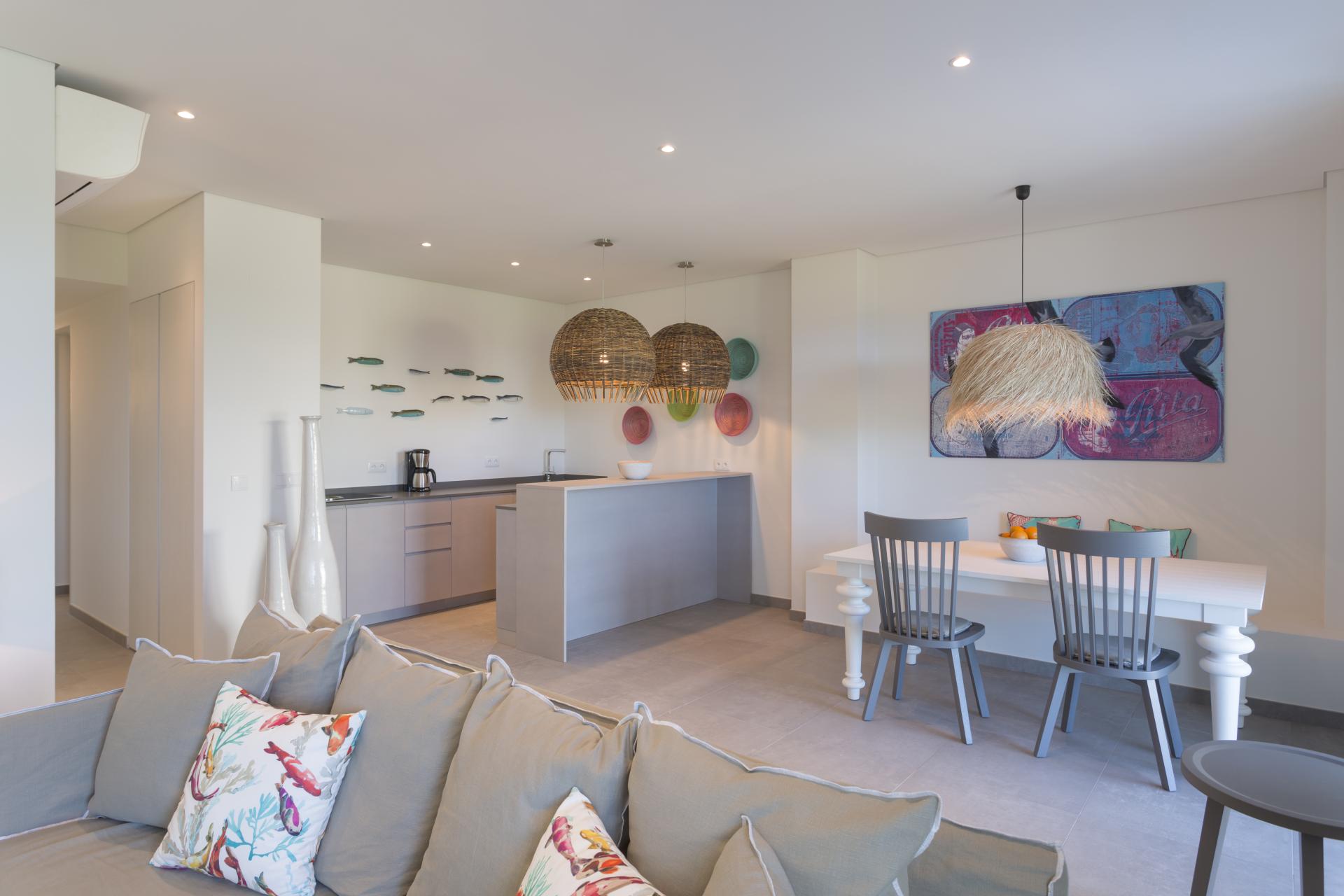 Sleek modern interior featuring sustainable design elements, showcasing JSH Algarve's signature style in an open kitchen-living space.