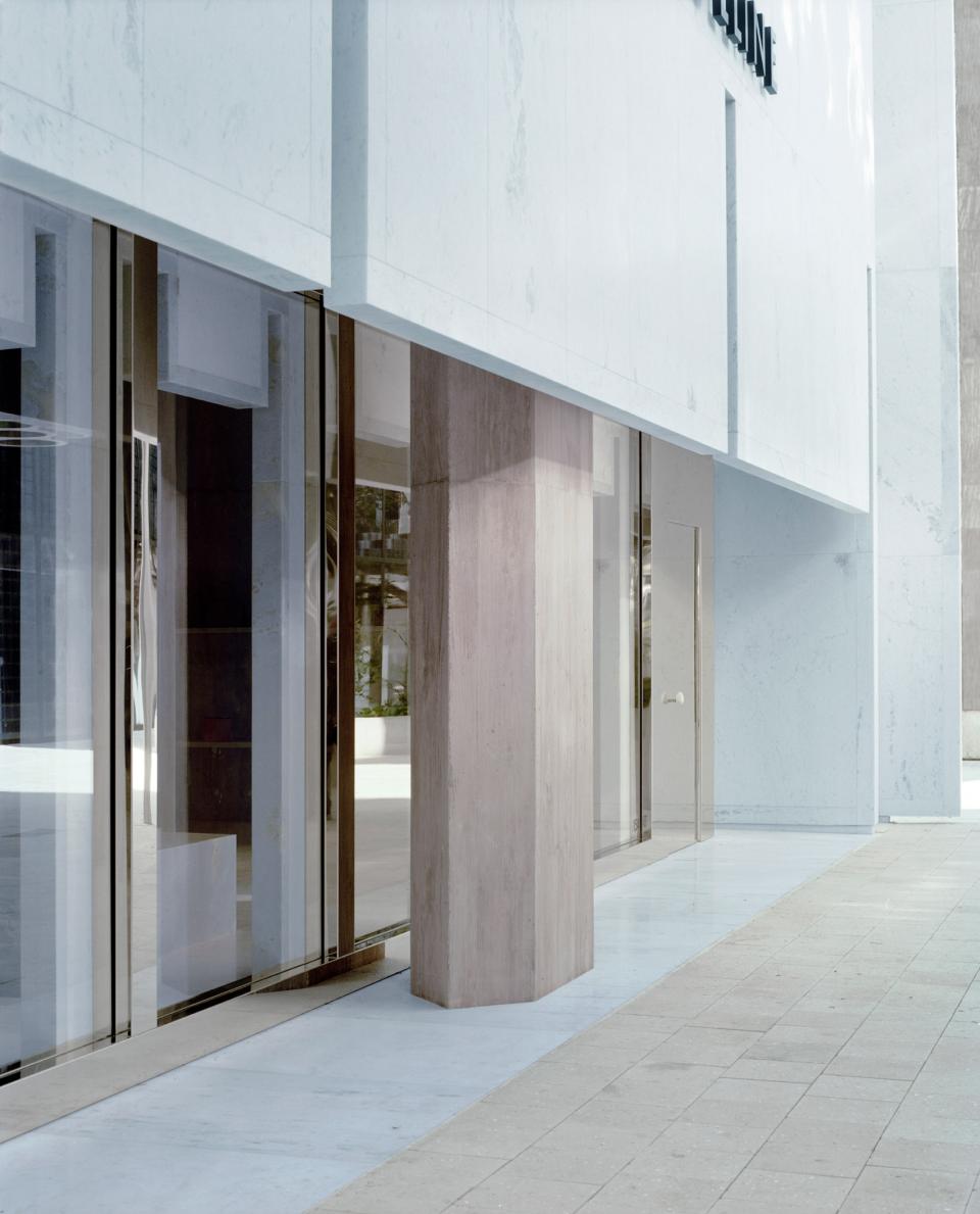 Céline's Miami store entrance features elegant marble surfaces and striking pyramid shapes, designed by Valerio Olgiati.