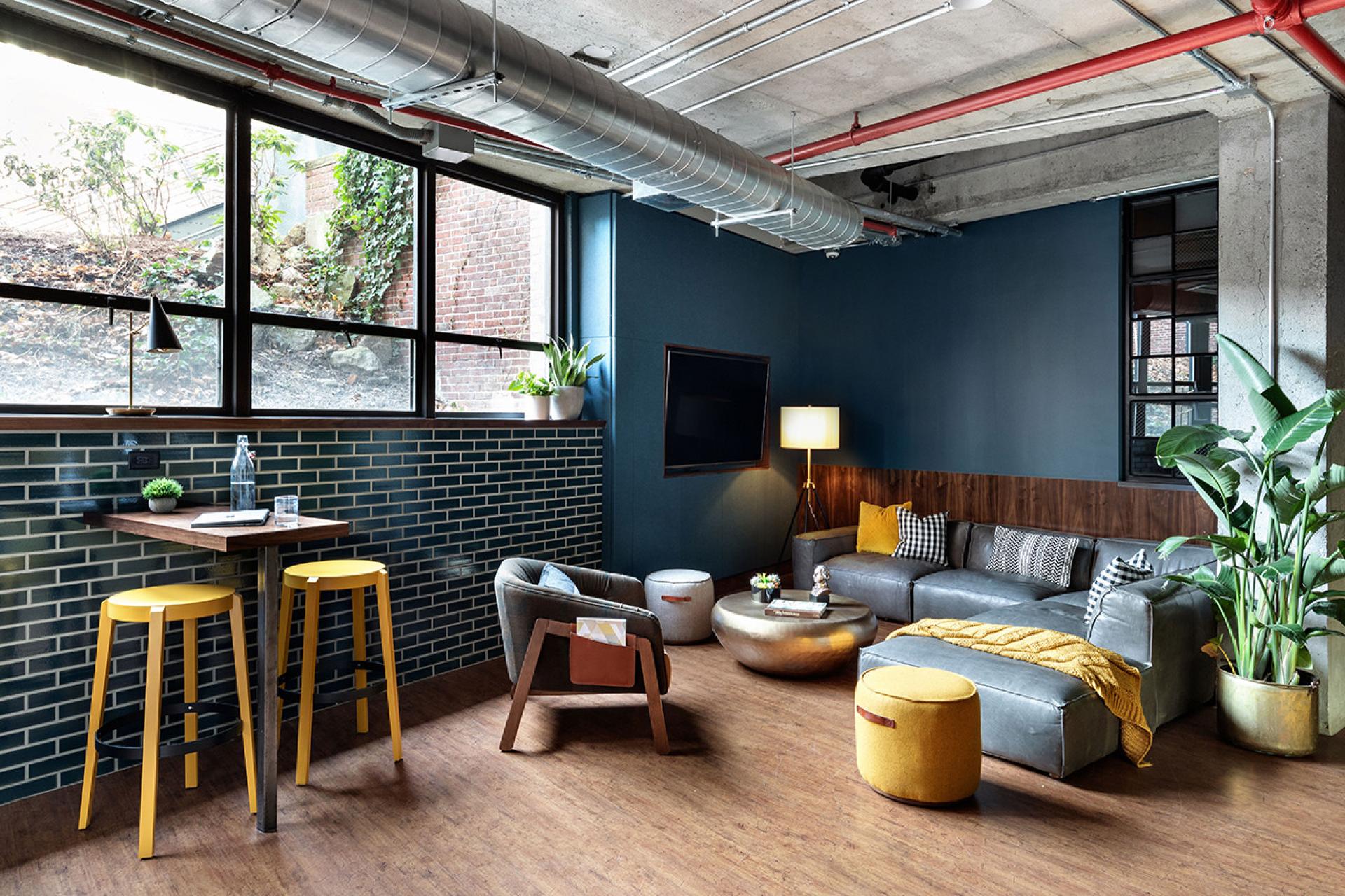 Stylish lounge area in The Revolution Hotel featuring modern decor, vibrant colors, and Boston-inspired design elements.