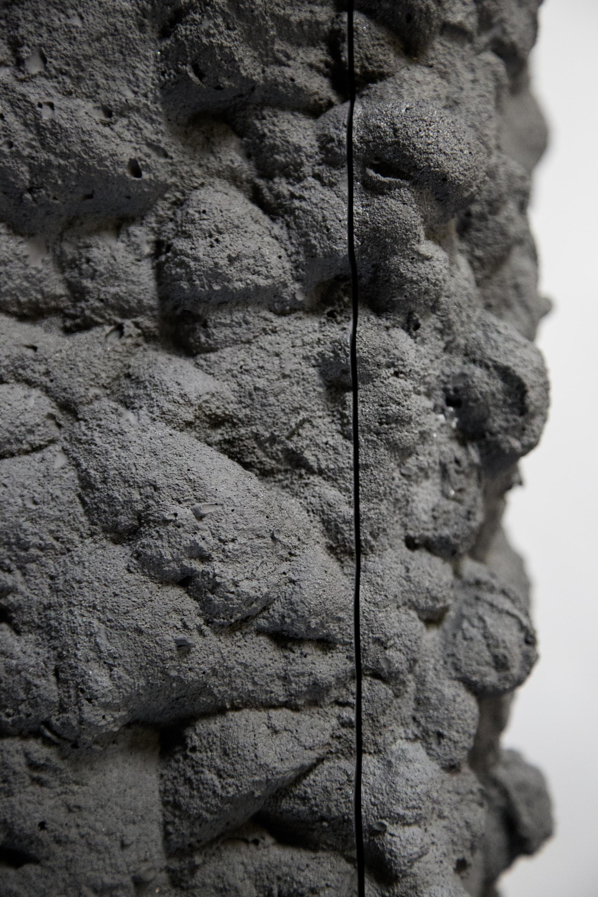 Textured concrete surface with subtle erosion patterns, illustrating the influence of natural elements in Gavin Stanley Keightley’s design work.