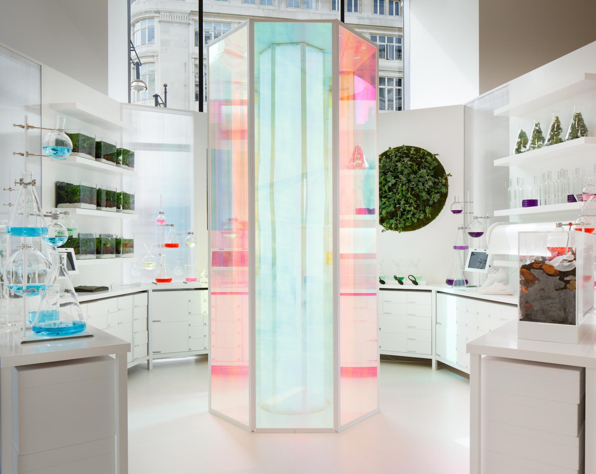 Colorful pop-up installation for Pangaia at Selfridges, featuring laboratory-style displays and vibrant plant decorations.