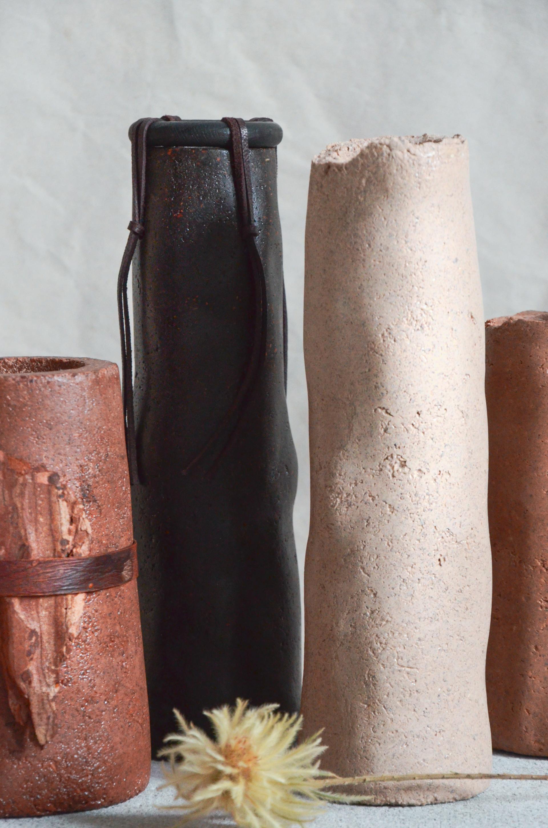 Unique ceramic vases in earthy tones and textures, showcasing sustainable design and innovative biomaterial use by Studio Sarmite.