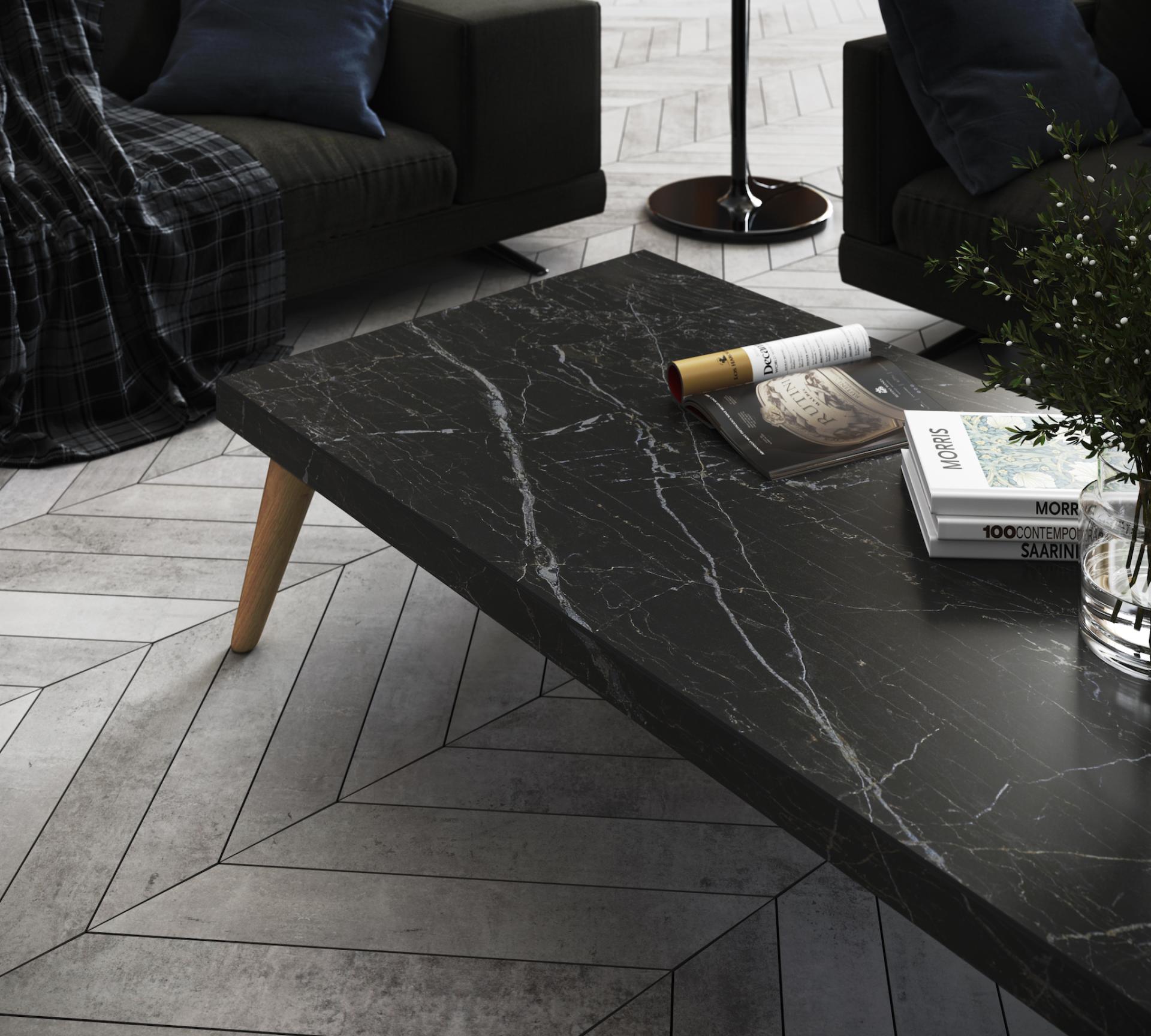 Stylish living room featuring a Dekton® table with a black marble effect and modern decor elements.