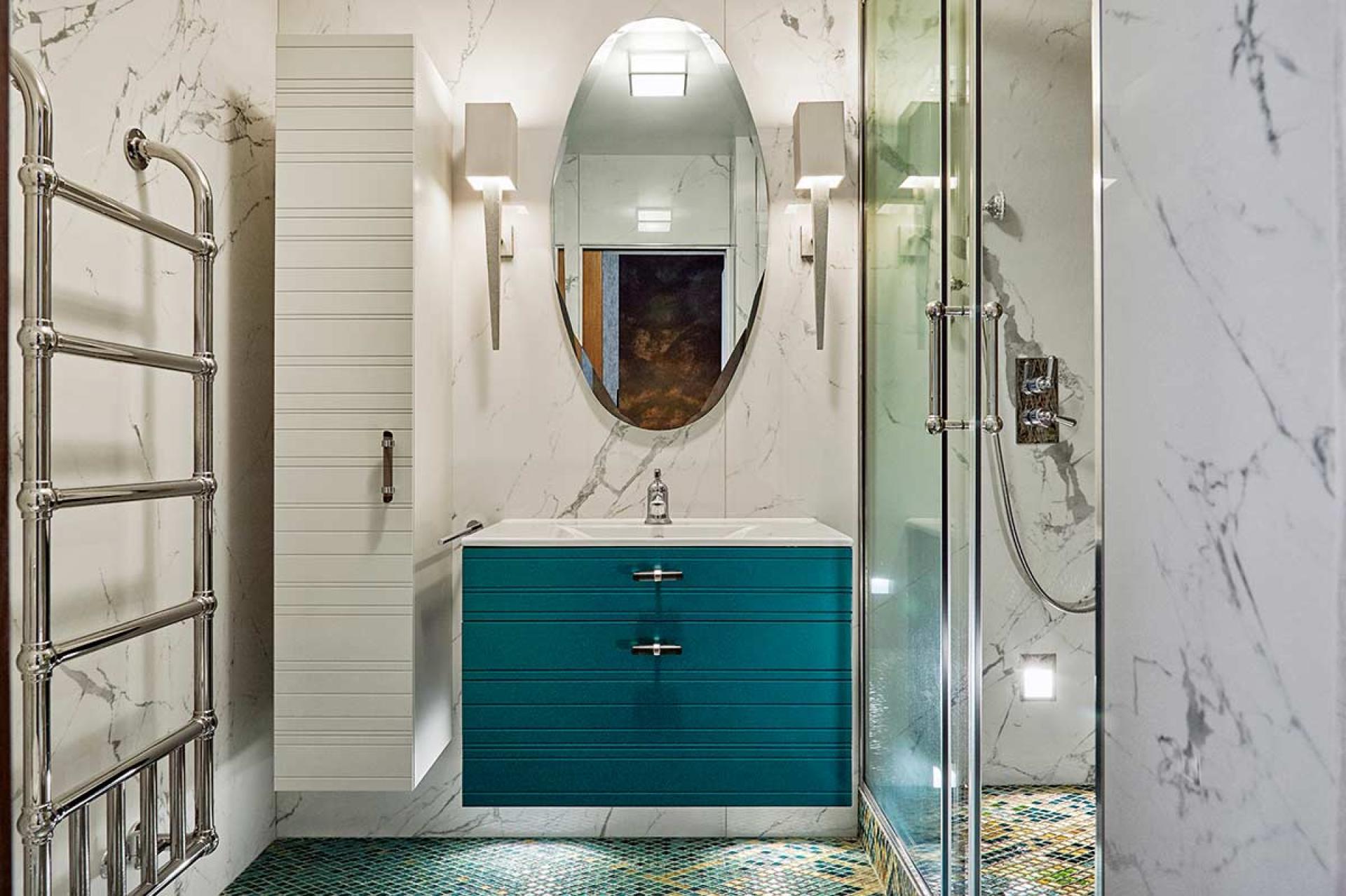 Luxurious bathroom renovation featuring teal cabinetry, marble walls, and modern fixtures inspired by Van Gogh's Starry Night.
