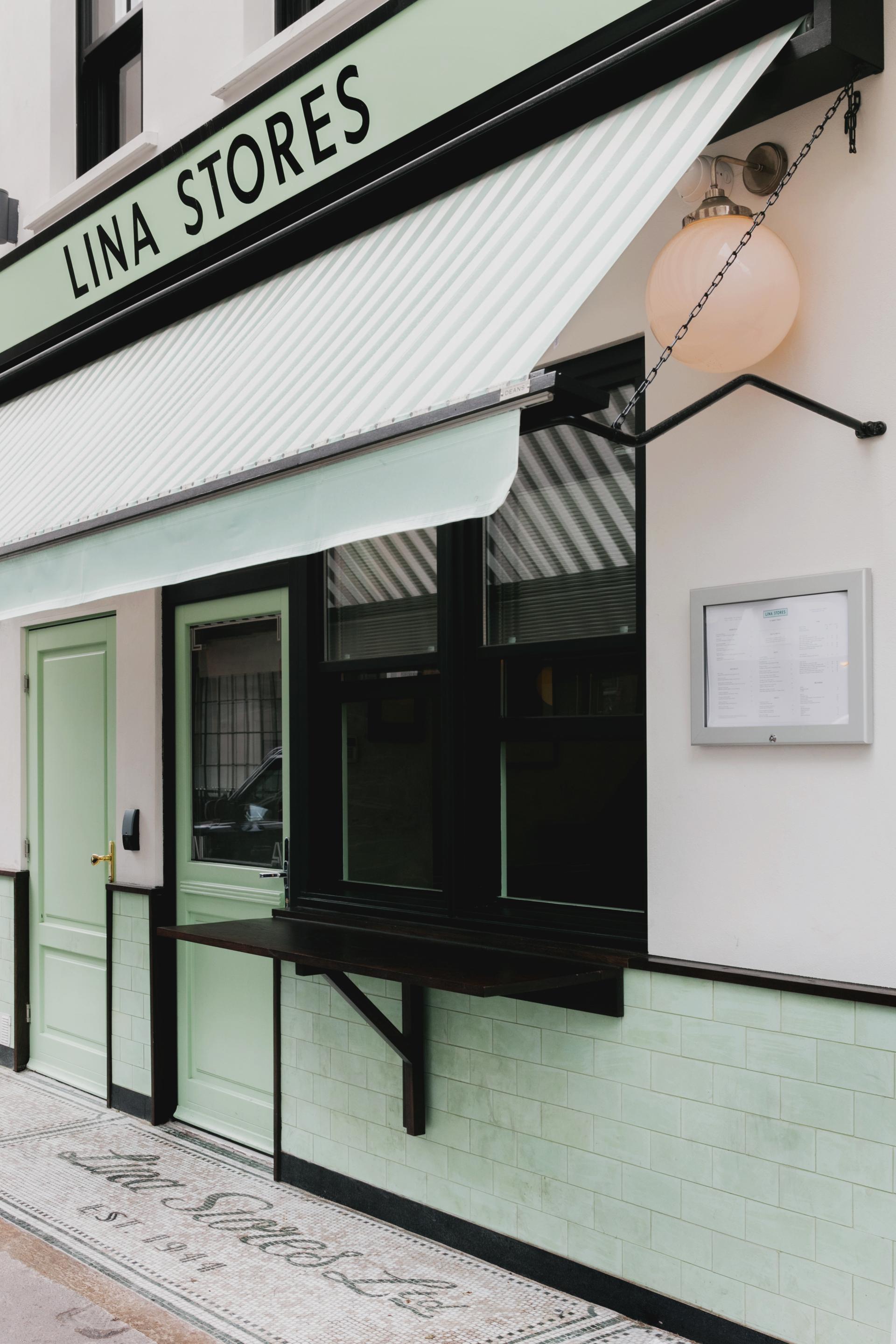Italian restaurant Lina Stores showcases Art Deco-inspired green and white striped exteriors on Brewer Street, Soho.