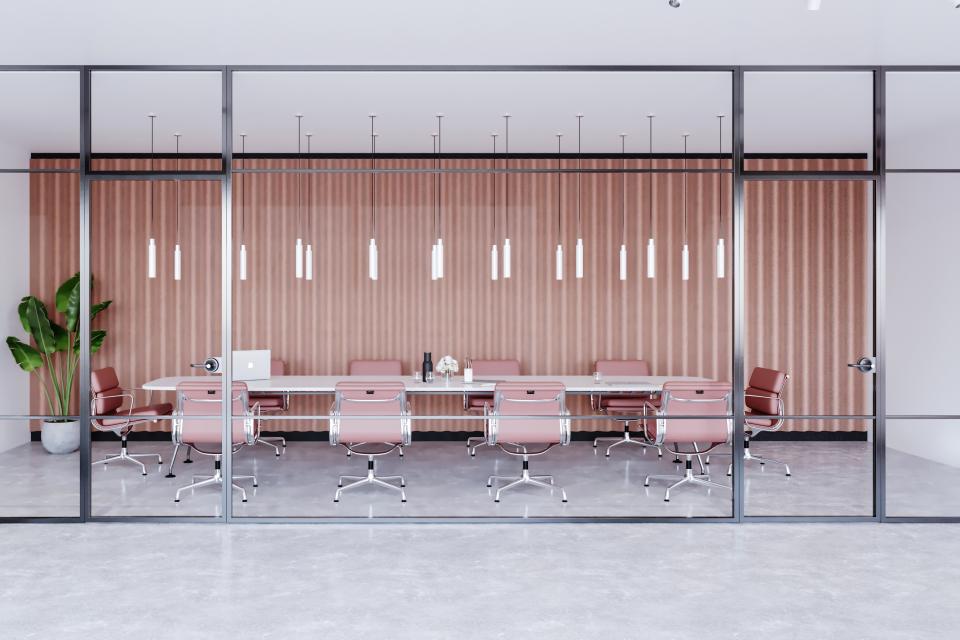 Modern conference room featuring Swell acoustic wall cladding, stylish furniture, and pendant lighting, promoting creative collaboration.