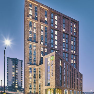Stunning view of Knight House, a modern student accommodation building at the University of Sheffield, illuminated at dusk.