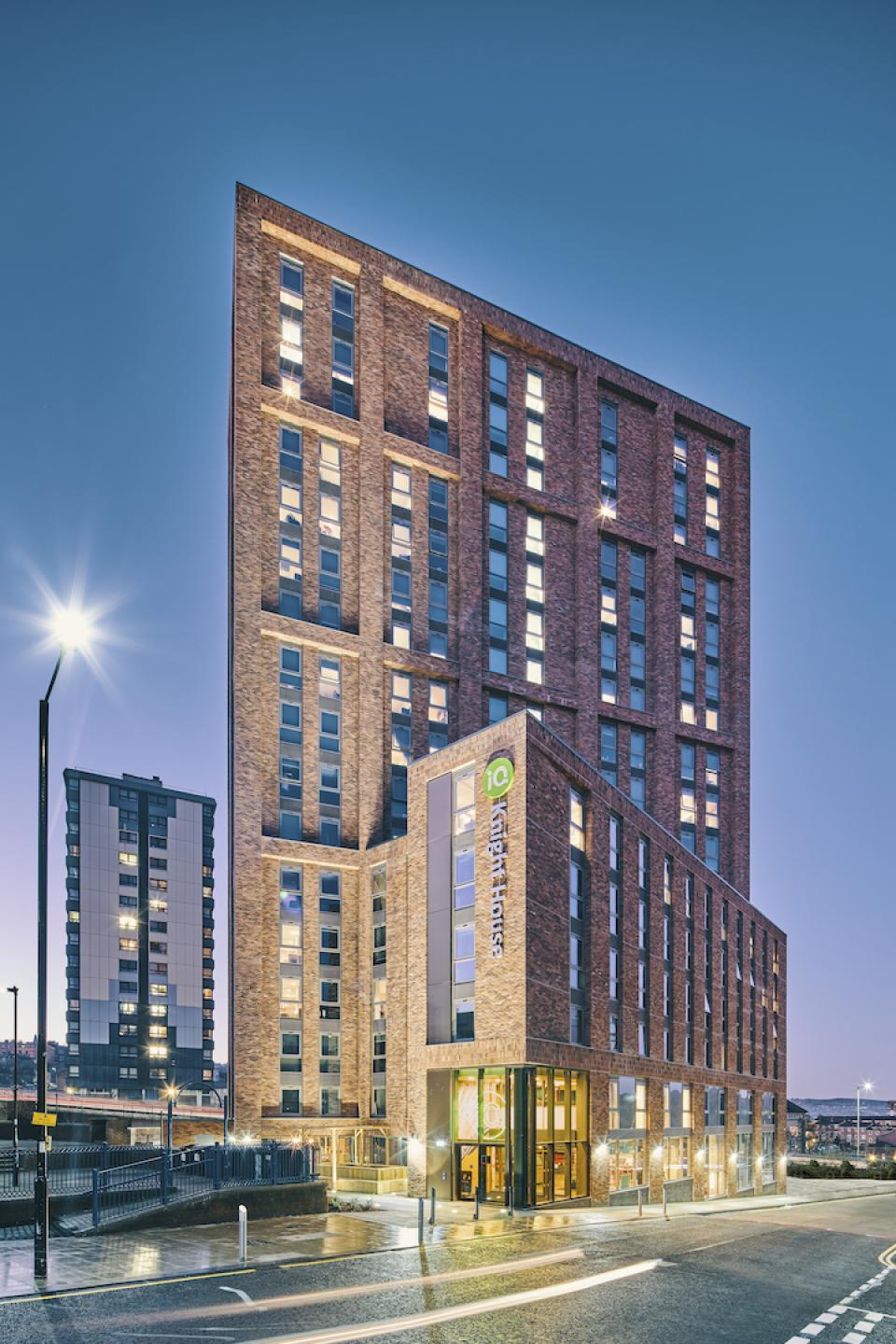 Stunning view of Knight House, a modern student accommodation building at the University of Sheffield, illuminated at dusk.