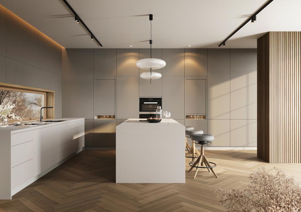 Modern kitchen featuring sleek cabinetry, RAUVISIO Cube island, and warm lighting, inspired by concrete textures.