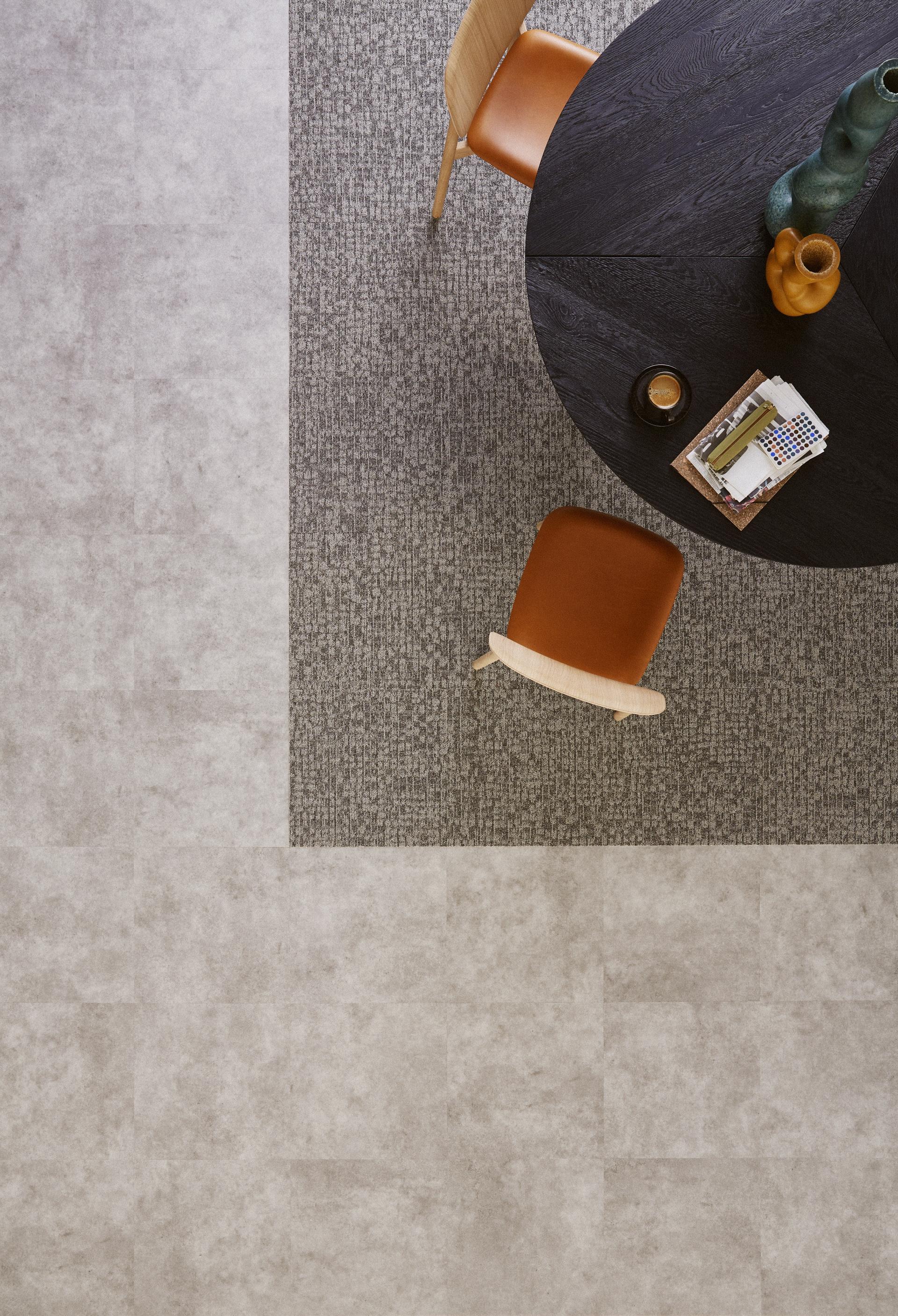Stylish workspace featuring Tarkett DESSO Orchard flooring, a round table, and elegant wooden chair with a unique dotted pattern.