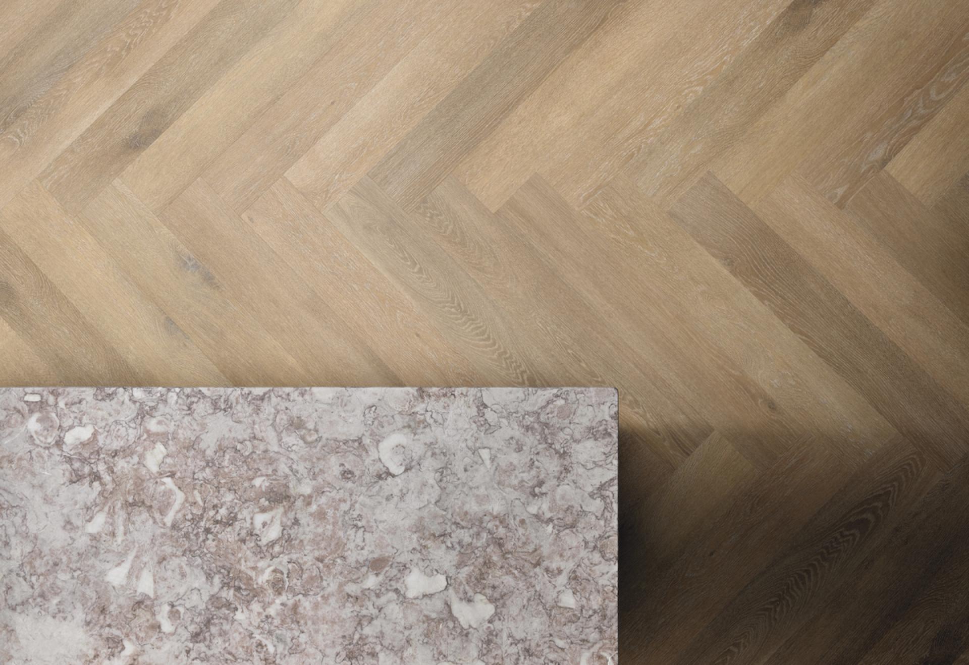 Elegant herringbone rigid core flooring from Karndean's Korlok Regent collection paired with a stylish countertop surface.