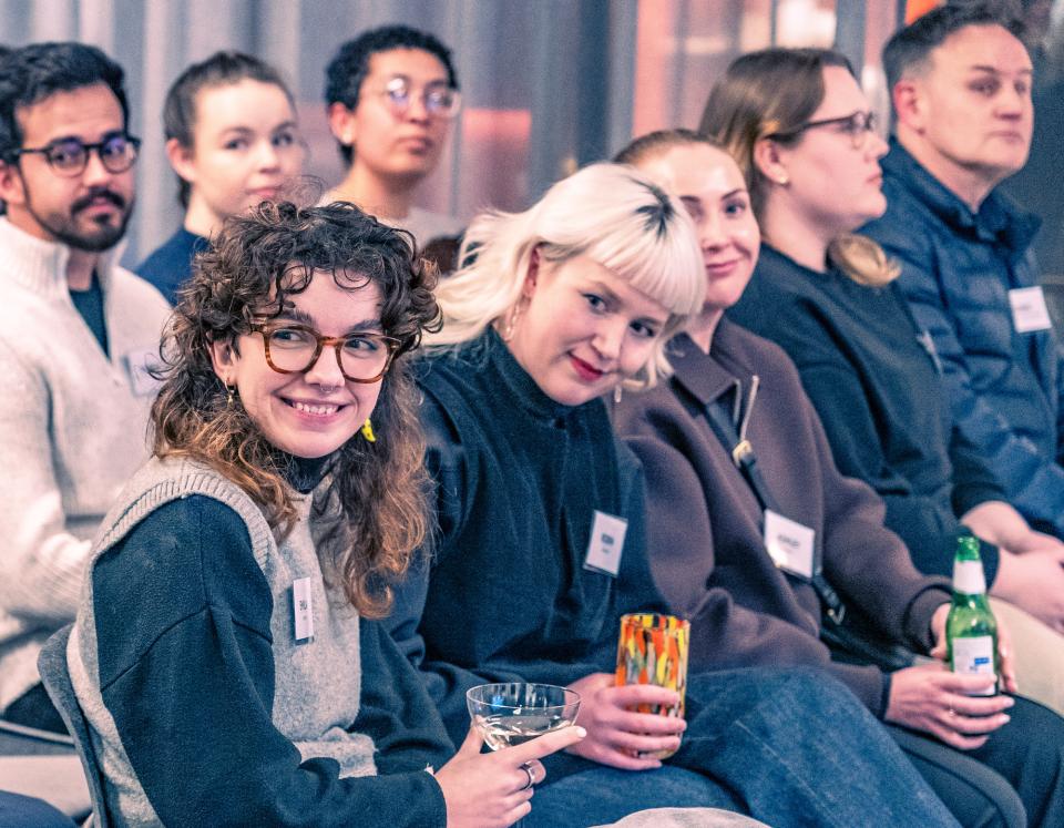 Engaged audience members at a seminar on net zero carbon buildings, demonstrating interest in sustainable architecture practices.