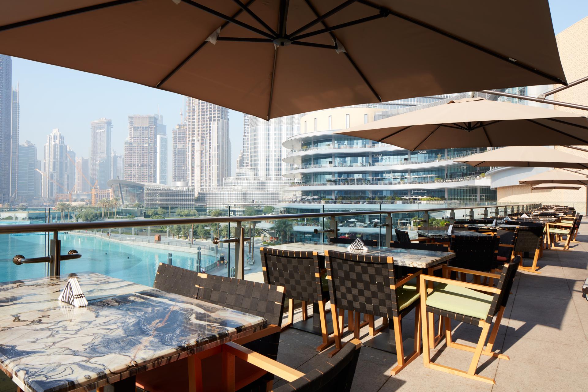 Stylish outdoor dining area at Third Avenue Boutique, with modern furniture and a view of Dubai's skyline.