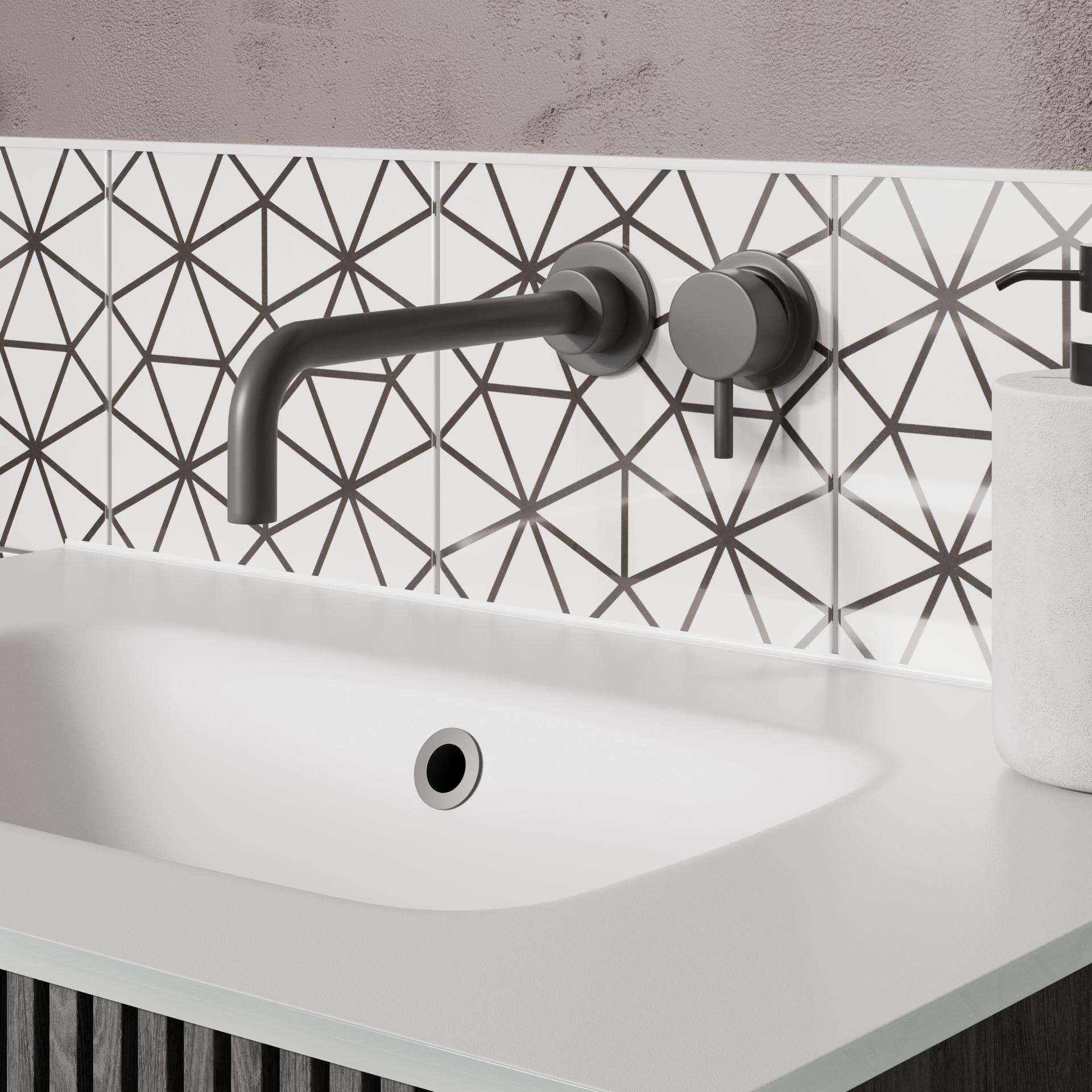 Modern bathroom design featuring bold geometric tiles, sleek black fixtures, and a minimalist white sink.