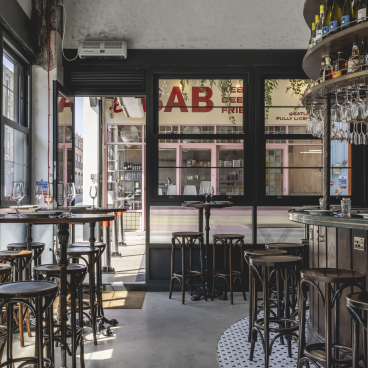 Interior of Bottle + Rye, a Parisian-inspired wine bar in South London, featuring stylish seating and a modern bar design.