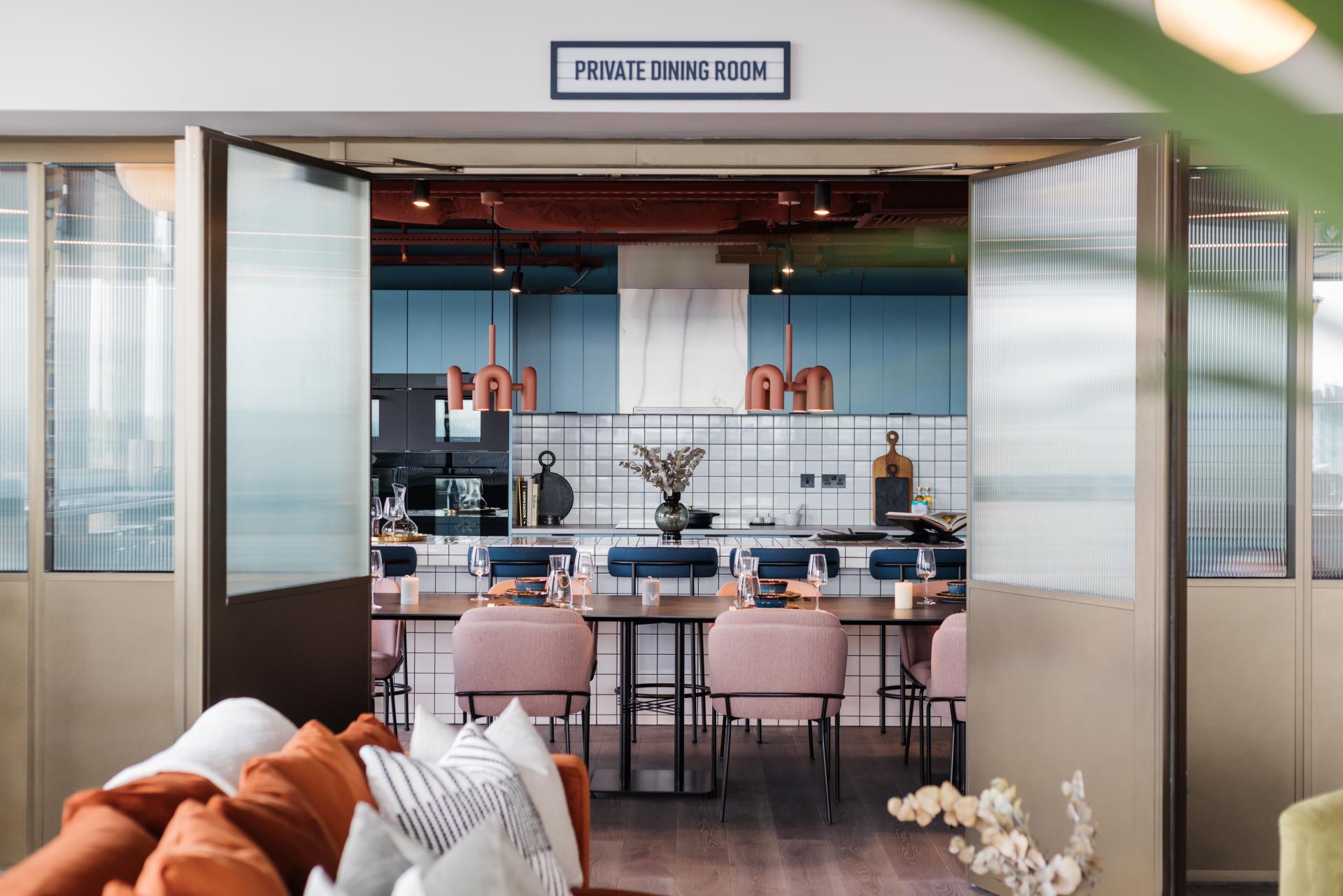 Stylish private dining room with modern decor, showcasing a well-designed kitchen and elegant dining setup for rental living.